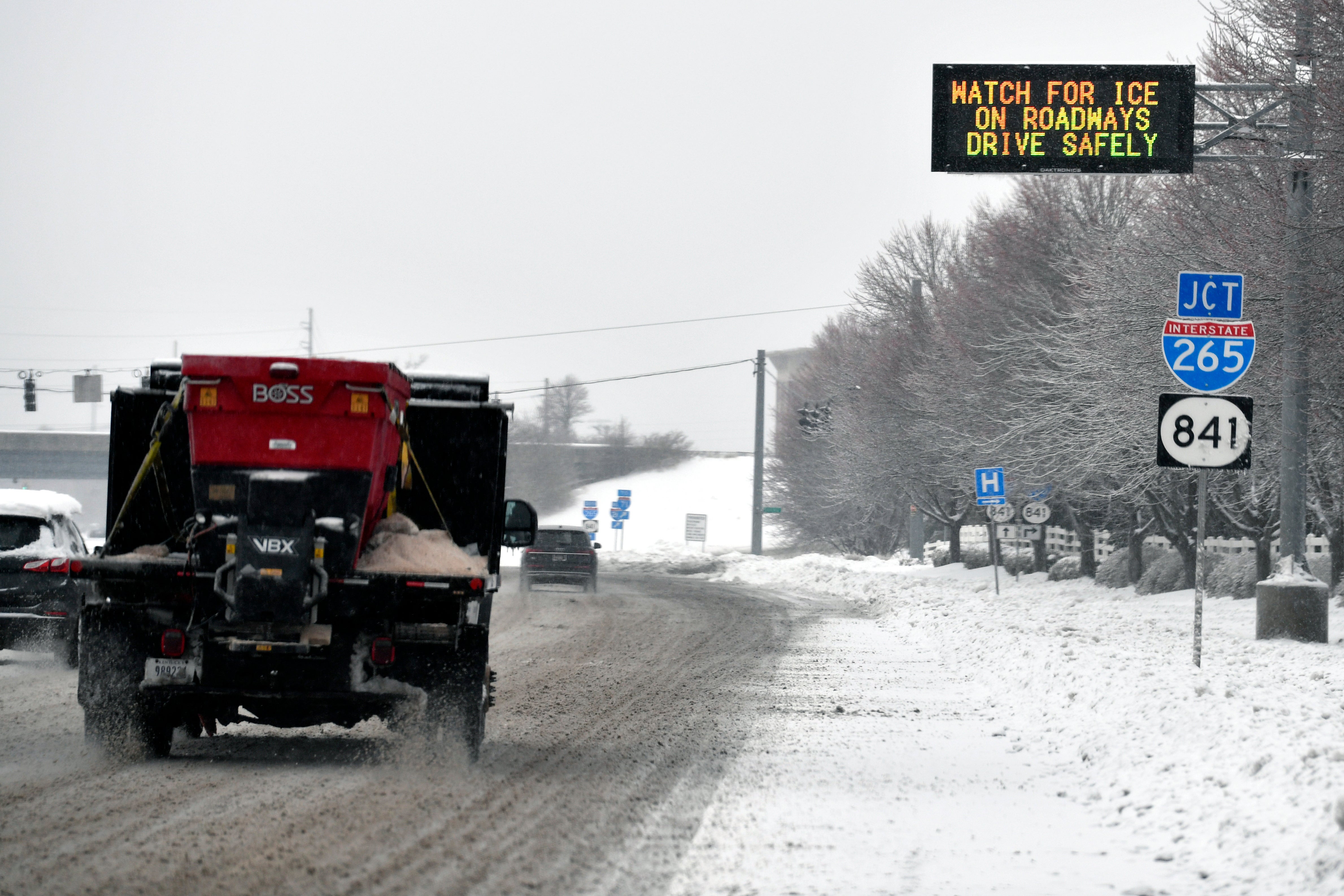 A truck sprays salt on the street during a winter storm in Louisville, Kentucky, on Monday. Very cold temperatures will persist there throughout the week