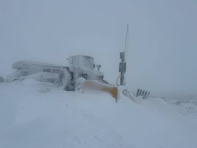 <p>Snow covers cars and a tractor outside Tan Hill Inn, Britain’s highest pub. </p>