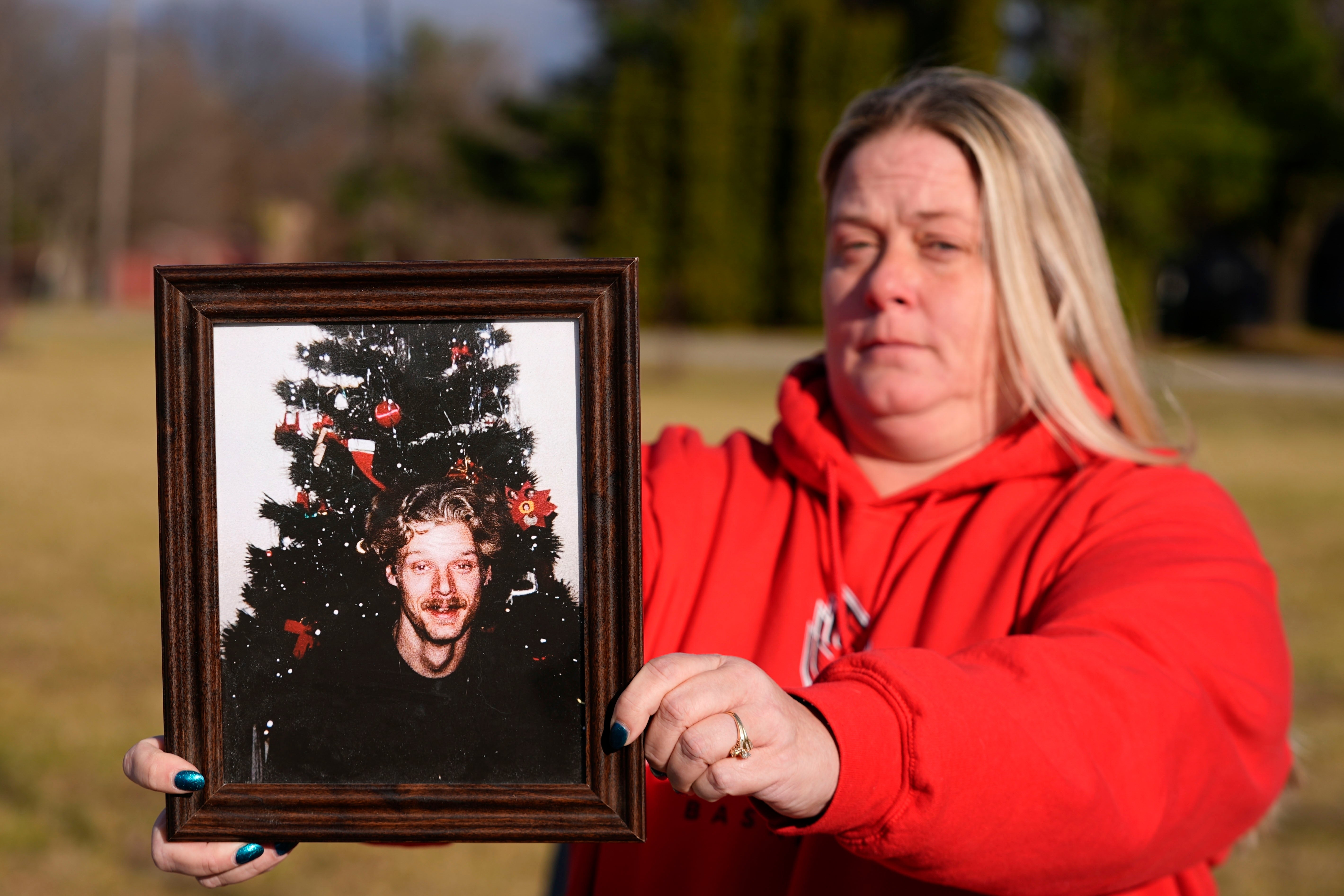 Shannon Doughty holds a photo of her late brother Allen Livingston, who was identified in October 2023 as the ninth known victim of suspected serial killer Herbert Baumeiste