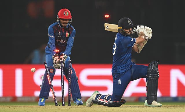 <p>Mark Wood of England is bowled by Rashid Khan of Afghanistan for the final wicket of the match during the ICC Men’s Cricket World Cup India 2023 </p>