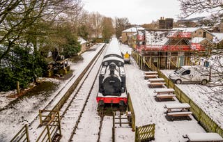 A train in snowy conditions at the Dales Countryside Museum in Hawes, North Yorkshire