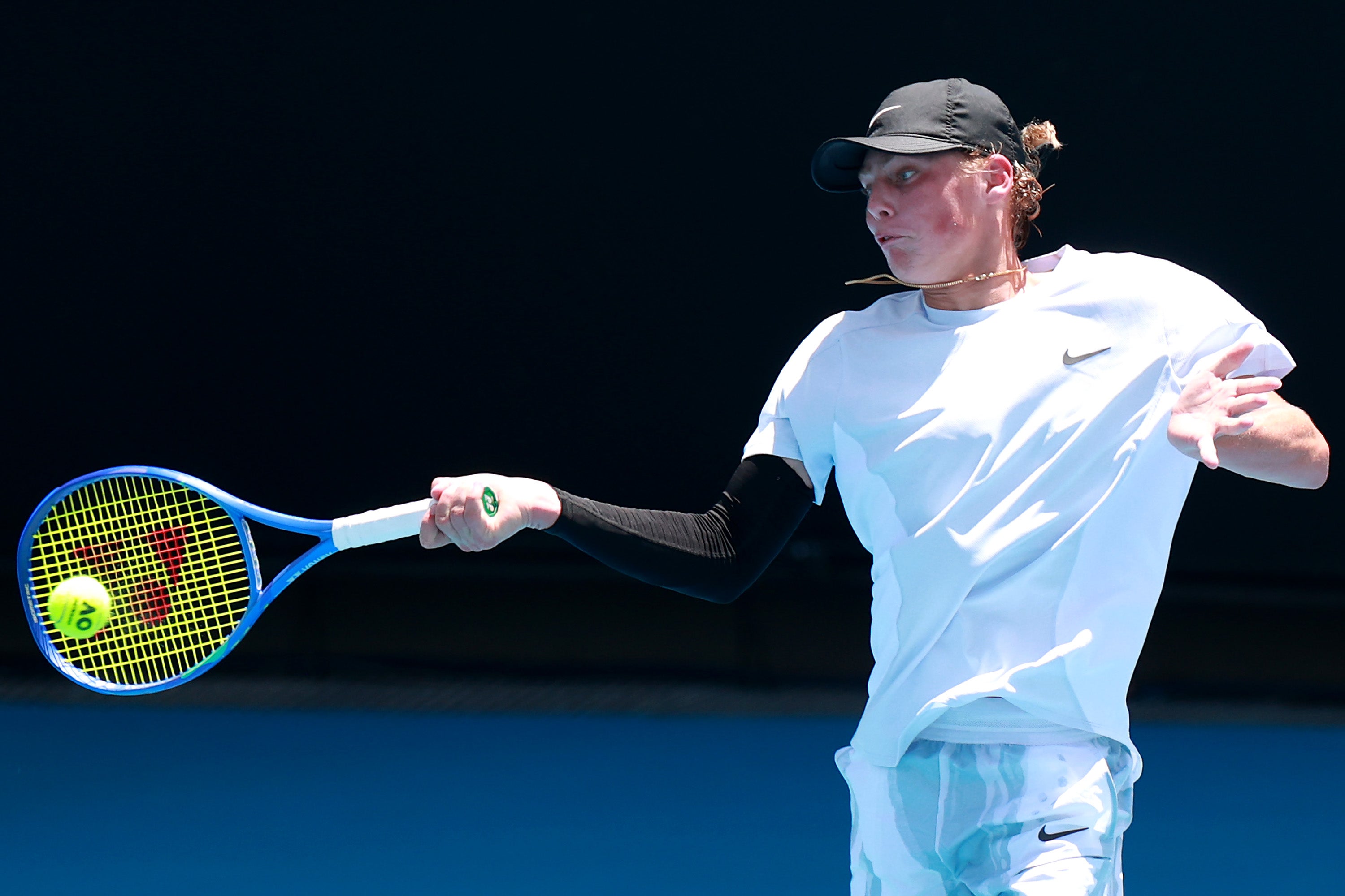 Cruz Hewitt of Australia plays a forehand in his Men's Qualifying Singles match against Nikoloz Basilashvili of Georgia