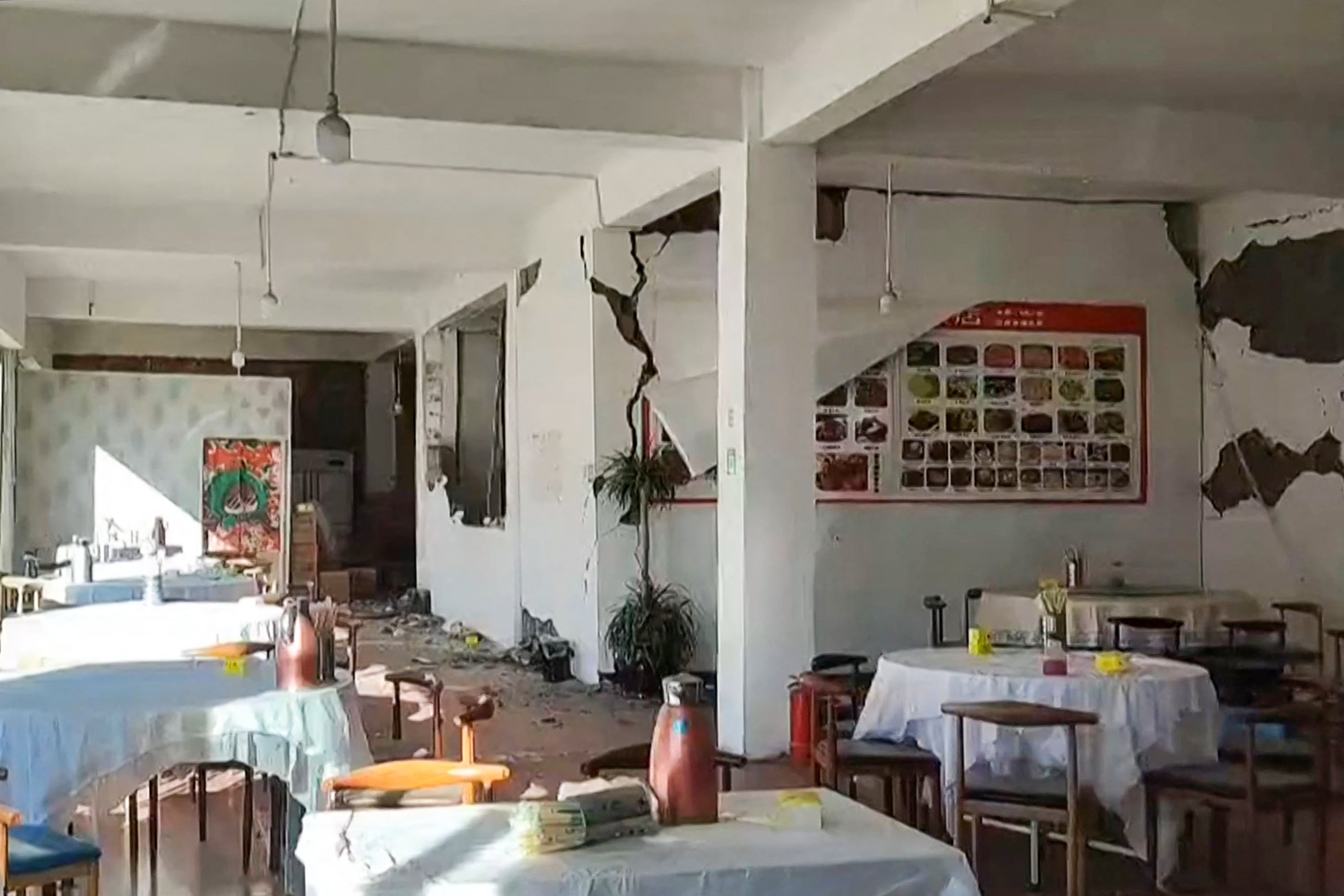 A still from a video shows cracks on the walls of a restaurant in Lhatse County in China's Tibet after an earthquake struck the area