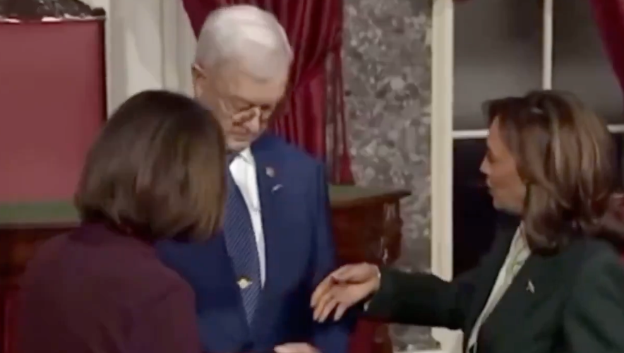 Harris congratulates the couple and extends her hand to Bruce Fischer, the husband of Nebraska Senator Deb Fischer at her swearing in