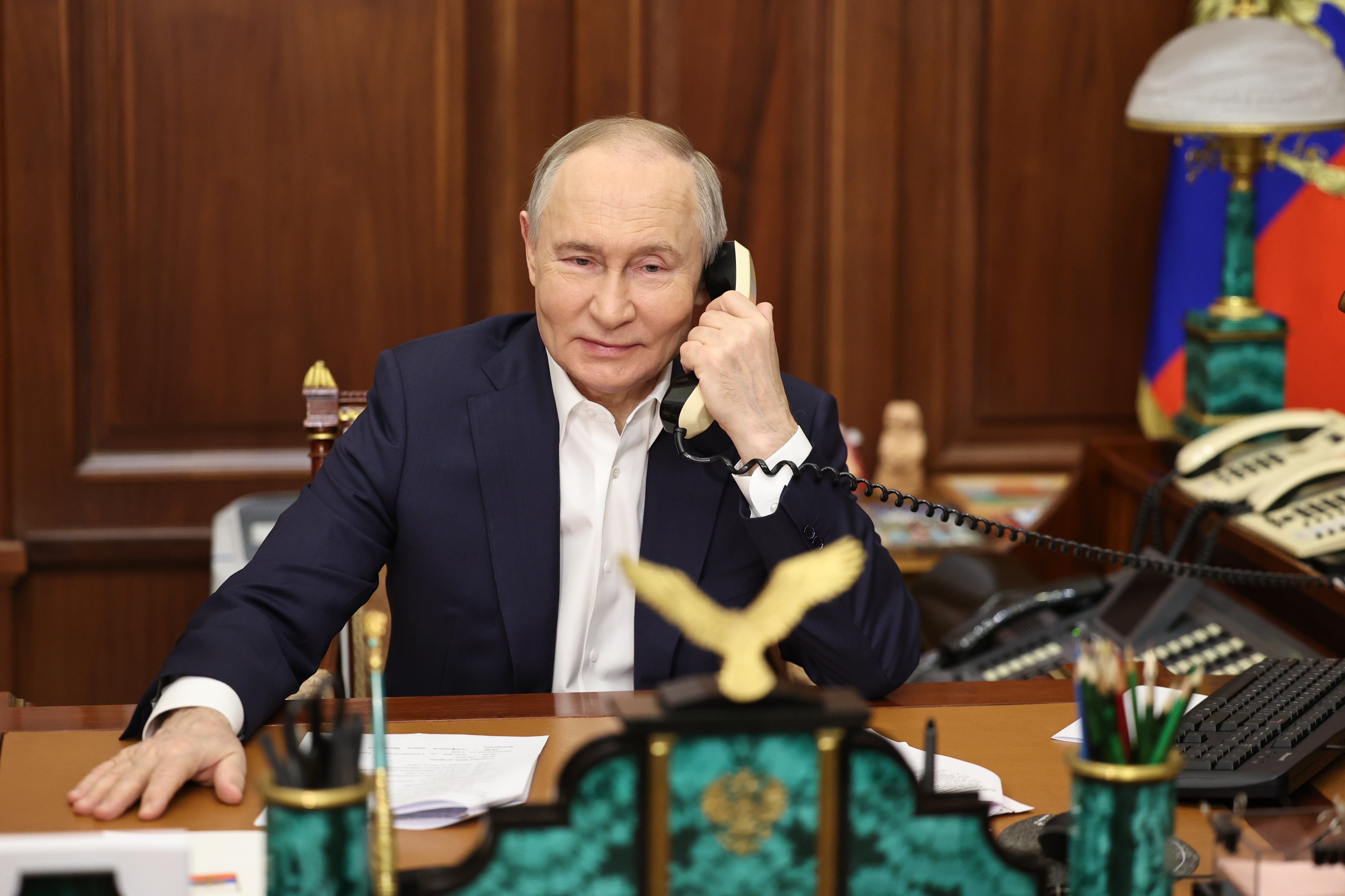 Russian President Vladimir Putin speaks on the phone with Arina Porkhal, a girl from Gorlovka in the Donetsk region, as part of the 'Christmas Tree Wish' nationwide charity campaign, fulfilling children's Christmas wishes, in Moscow, Russia, on 07 January 2025