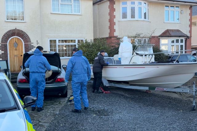 Forensic police officers search a boat and a car on the driveway of a property in Anthony’s Avenue, Poole (Ben Mitchell/PA)