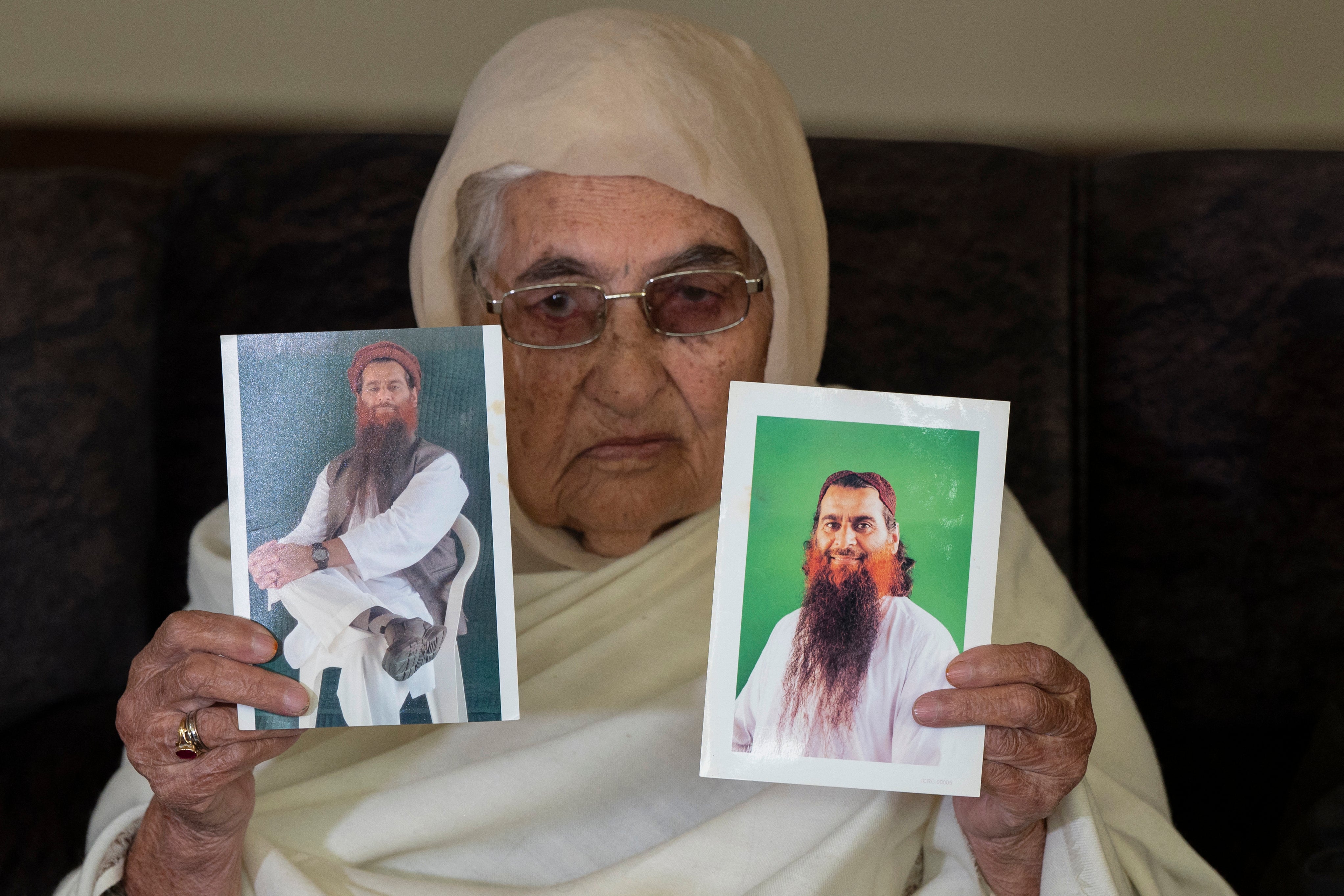 The U.S. is considering giving up Muhammad Rahim al Afghani in the deal. Rahim’s mother holds up photos of her son in November 2023, calling for his release