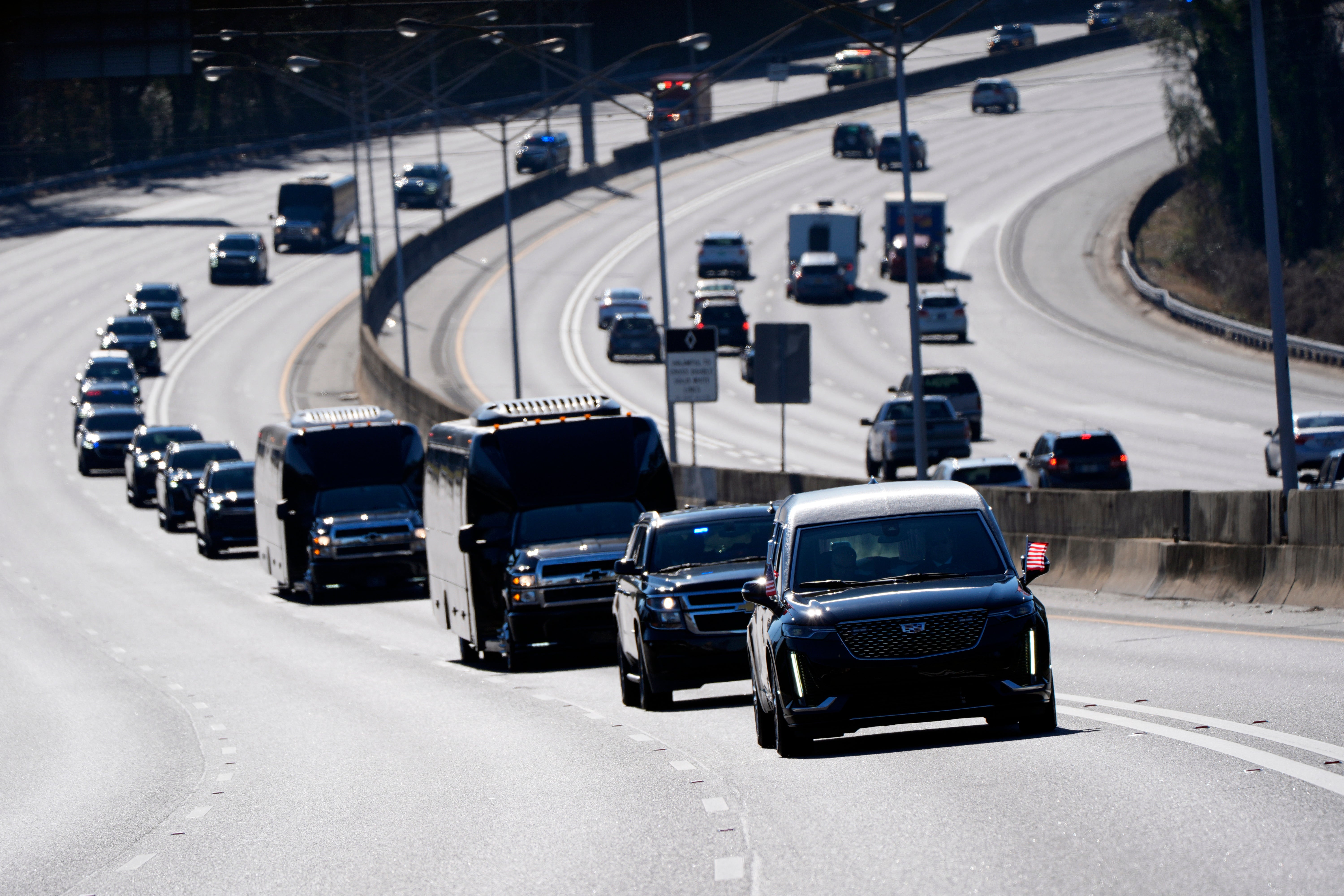 The hearse carrying the casket of former President Jimmy Carter passes through Atlanta on its way to Dobbins Air Reserve Base on January 7, 2025 in Atlanta, Georgia