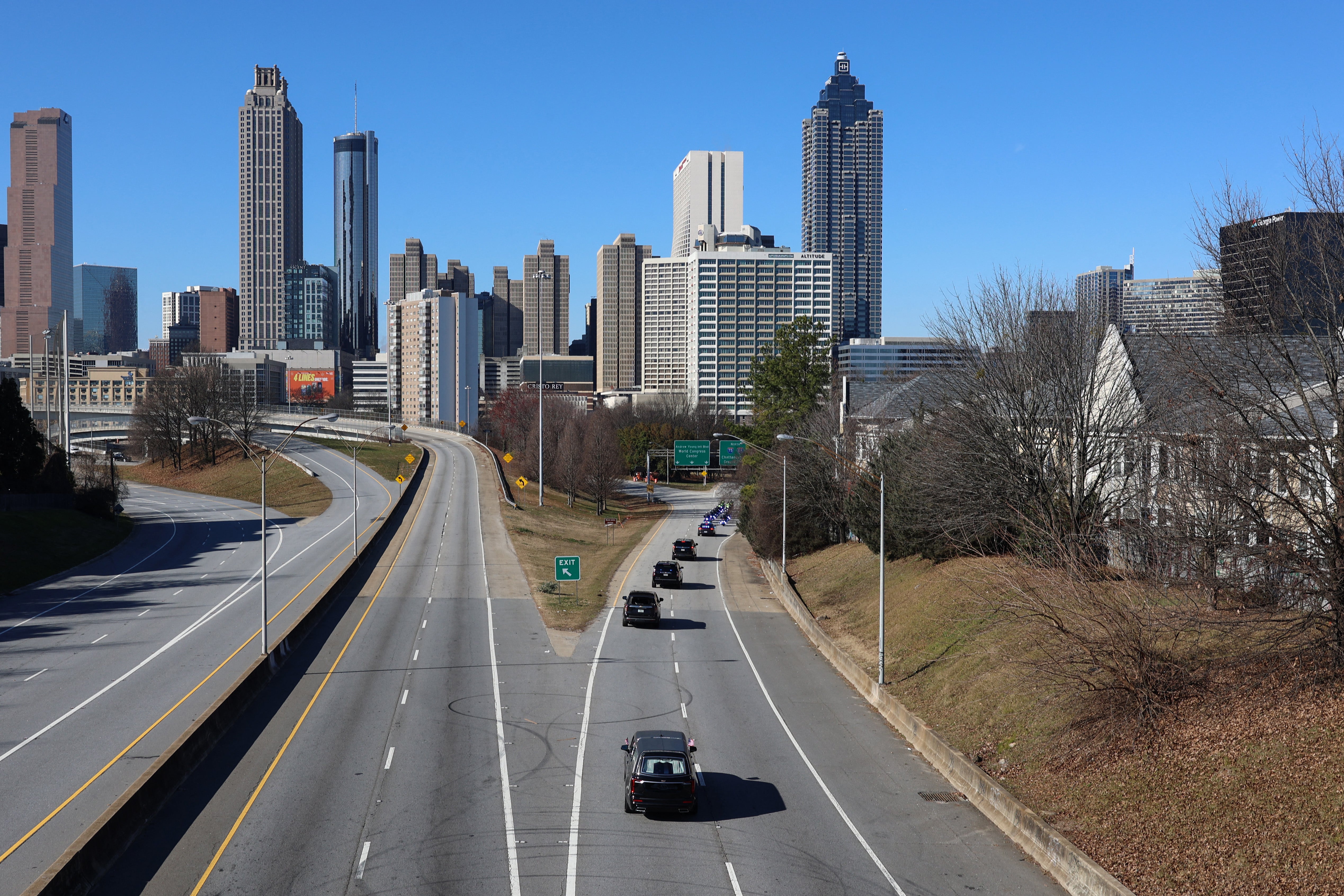 The motorcade with the hearse carrying the casket of former US President Jimmy Carter drives through Atlanta, Georgia on its way to Dobbins Air Reserve Base on January 7, 2025