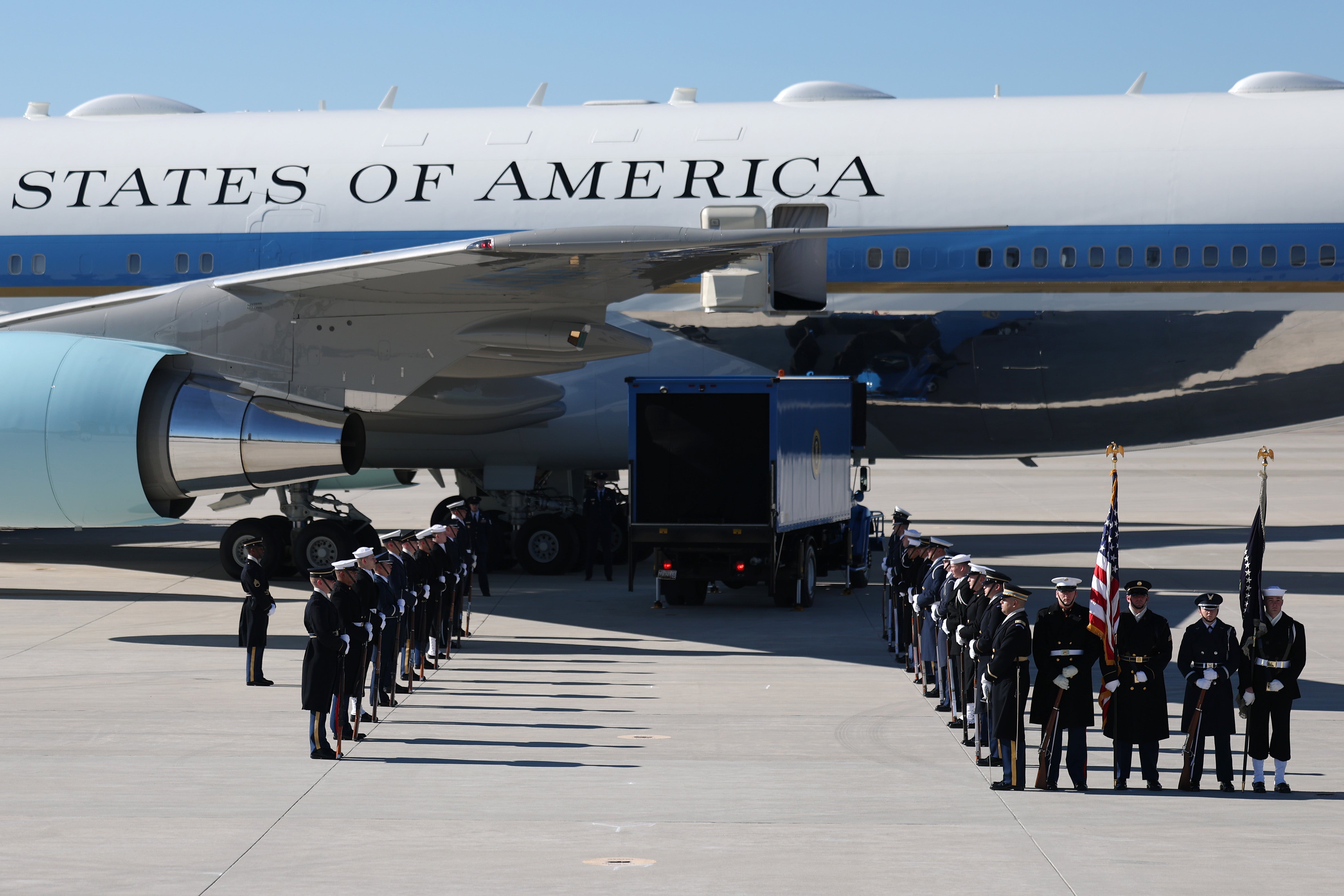 Members of a military honor guard await the arrival of former U.S. President Jimmy Carter's casket as it is transported to Washington, DC at Dobbins Air Reserve Base on January 7, 2025 in Marietta, Georgia