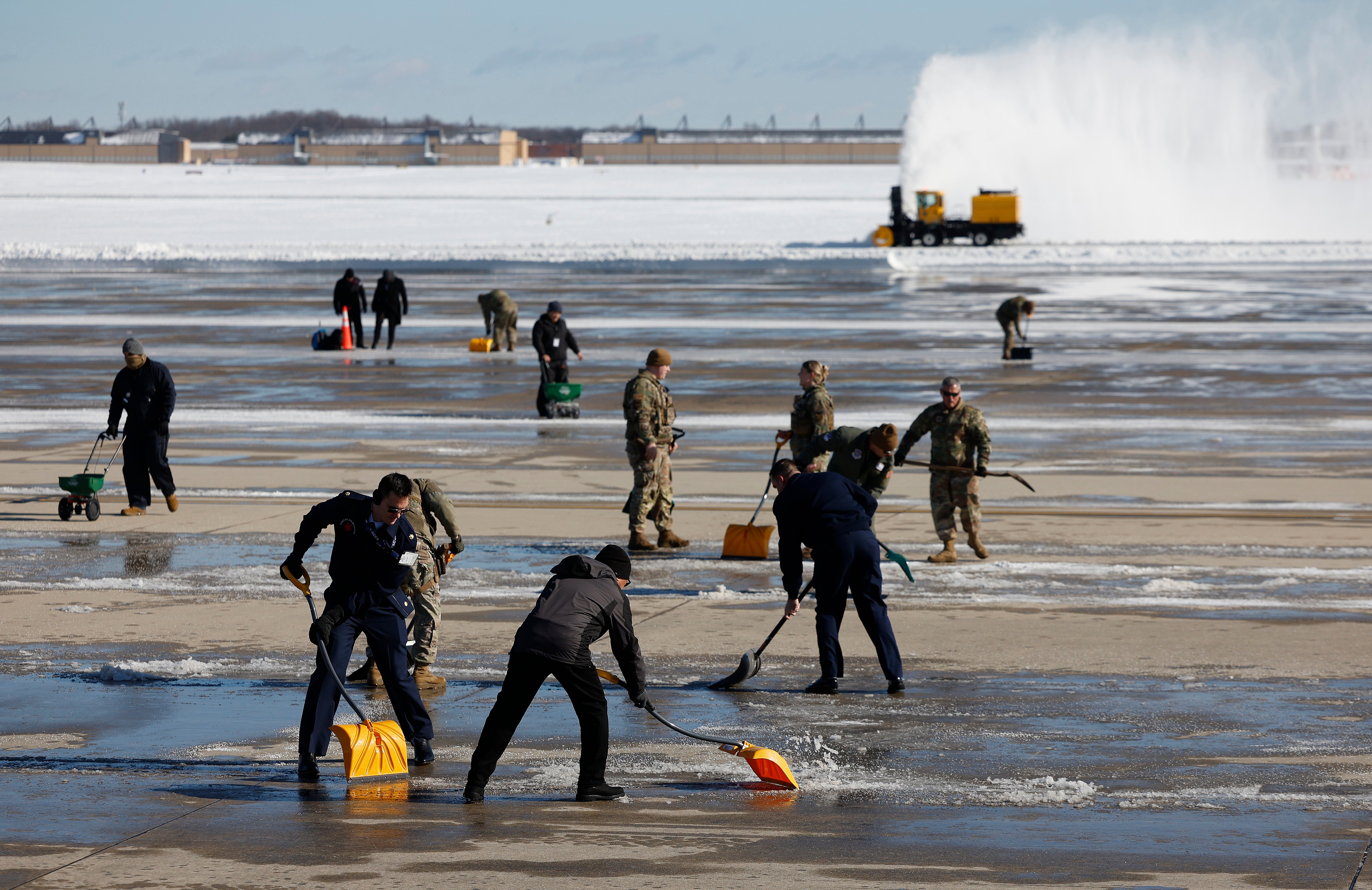 Civil engineers clear the tarmac before the arrival ceremony for the remains of U.S. President Jimmy Carter at Joint Base Andrews on January 07, 2025 in Joint Base Andrews, Maryland