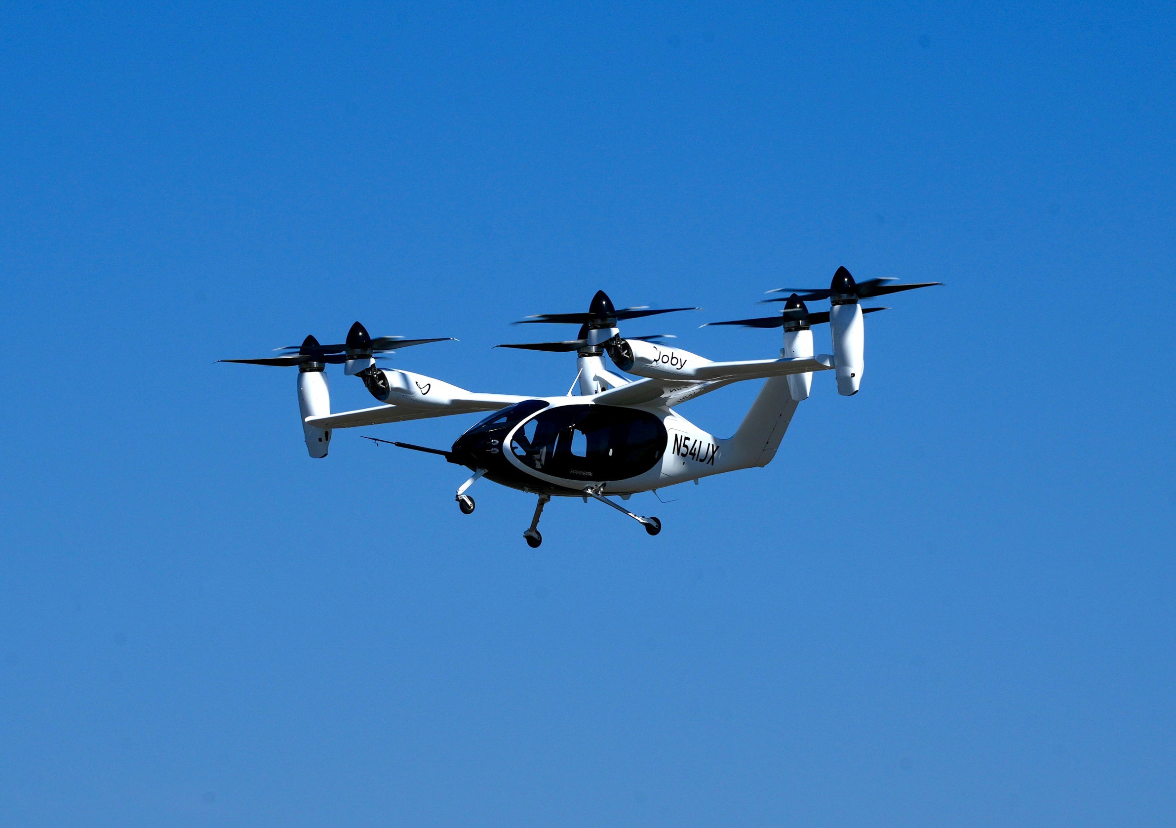 An ‘electric vertical take-off and landing’ aircraft built by Joby Aviation flies over an airfield in Marina