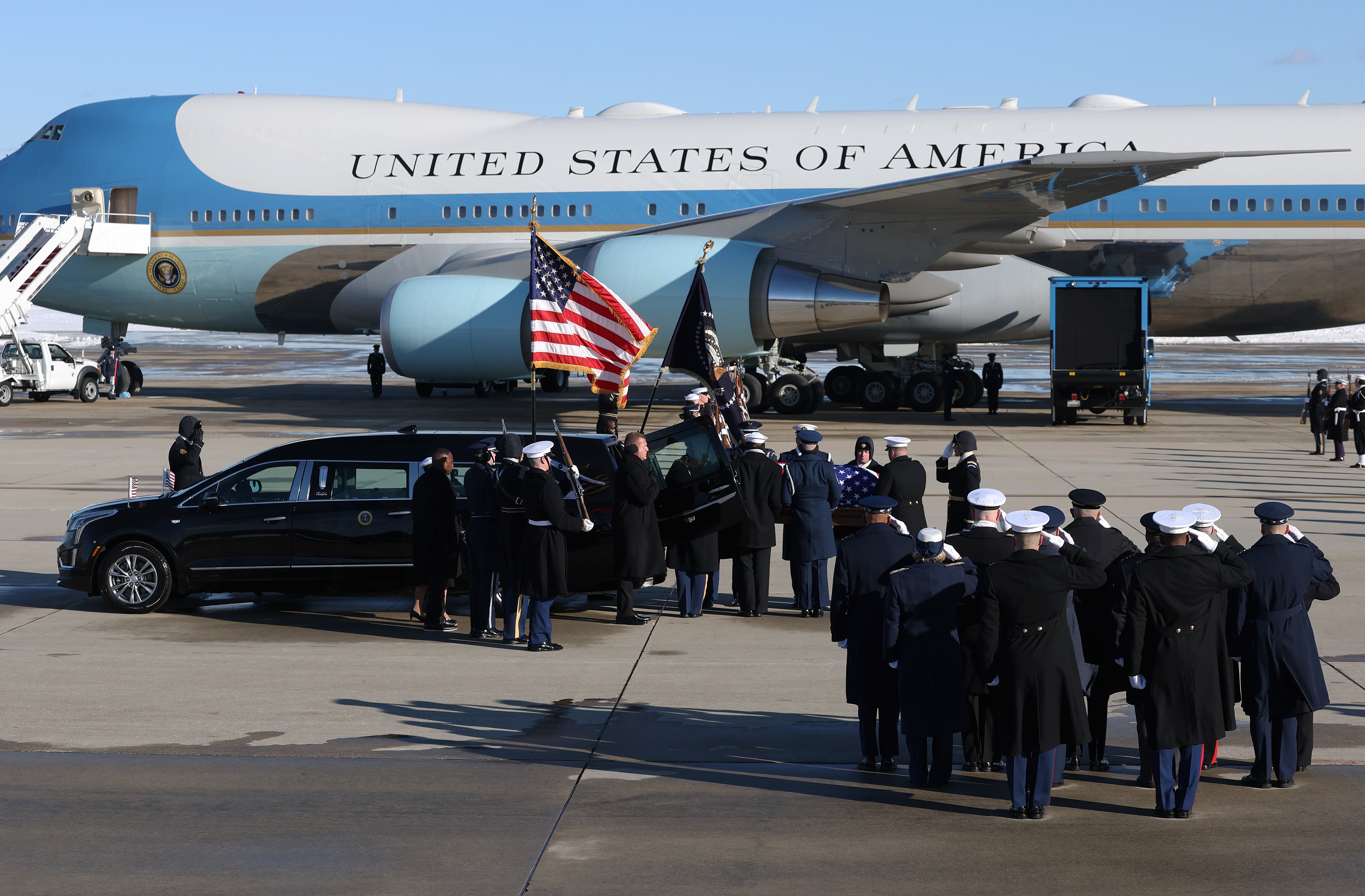 Members of the military salute as an honor cordon transfers the flag-draped casket of former U.S. President Jimmy Carter to a hearse during an arrival ceremony on January 07, 2025 in Joint Base Andrews, Maryland