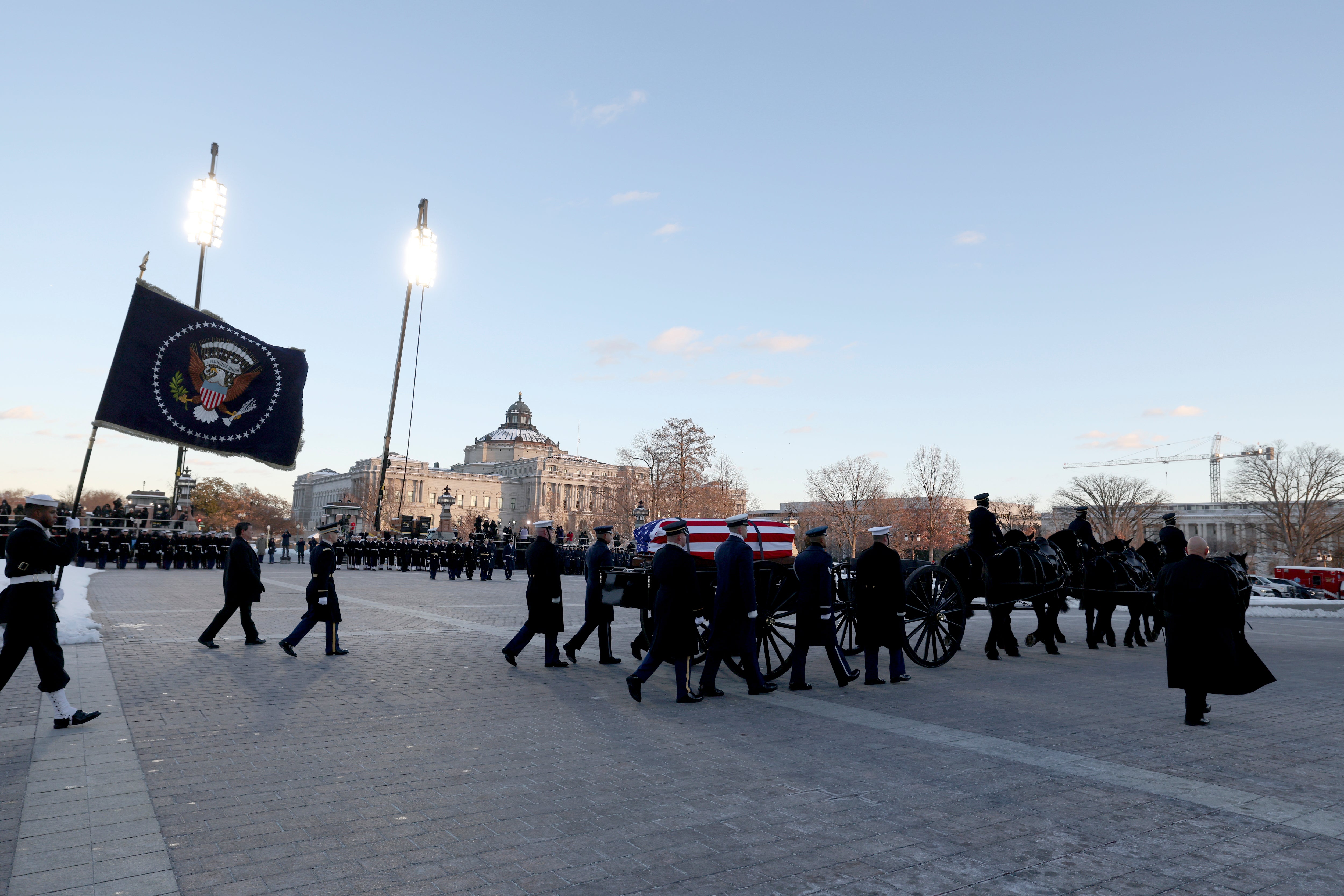 The flag-draped casket of former President Jimmy Carter is transported on a horse-drawn caisson to the U.S. Capitol on January 7, 2025 in Washington, DC