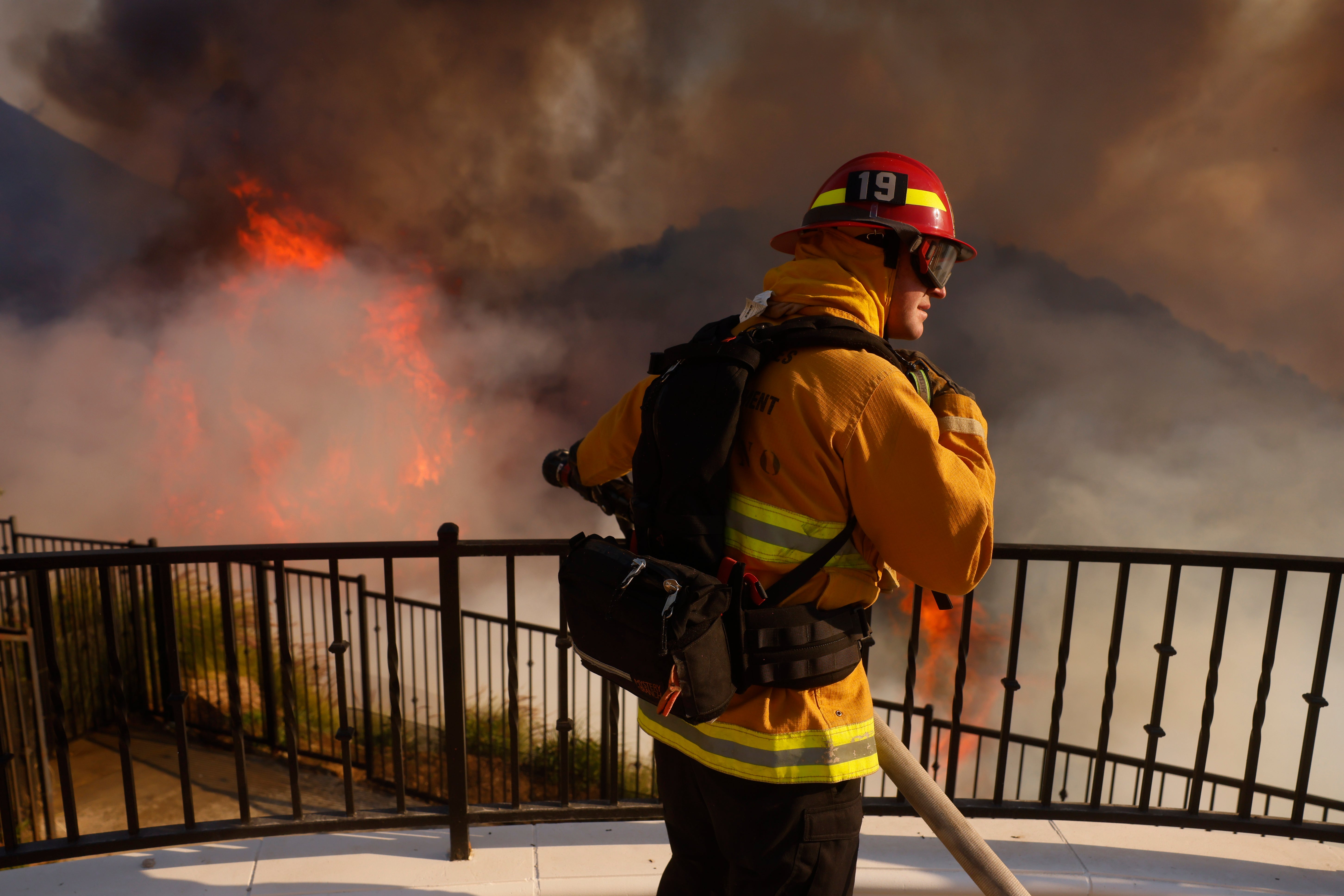 A firefighter takes on a blaze in Southern California. Officials are warning residents to be ready to evacuate as the fires continue to grow