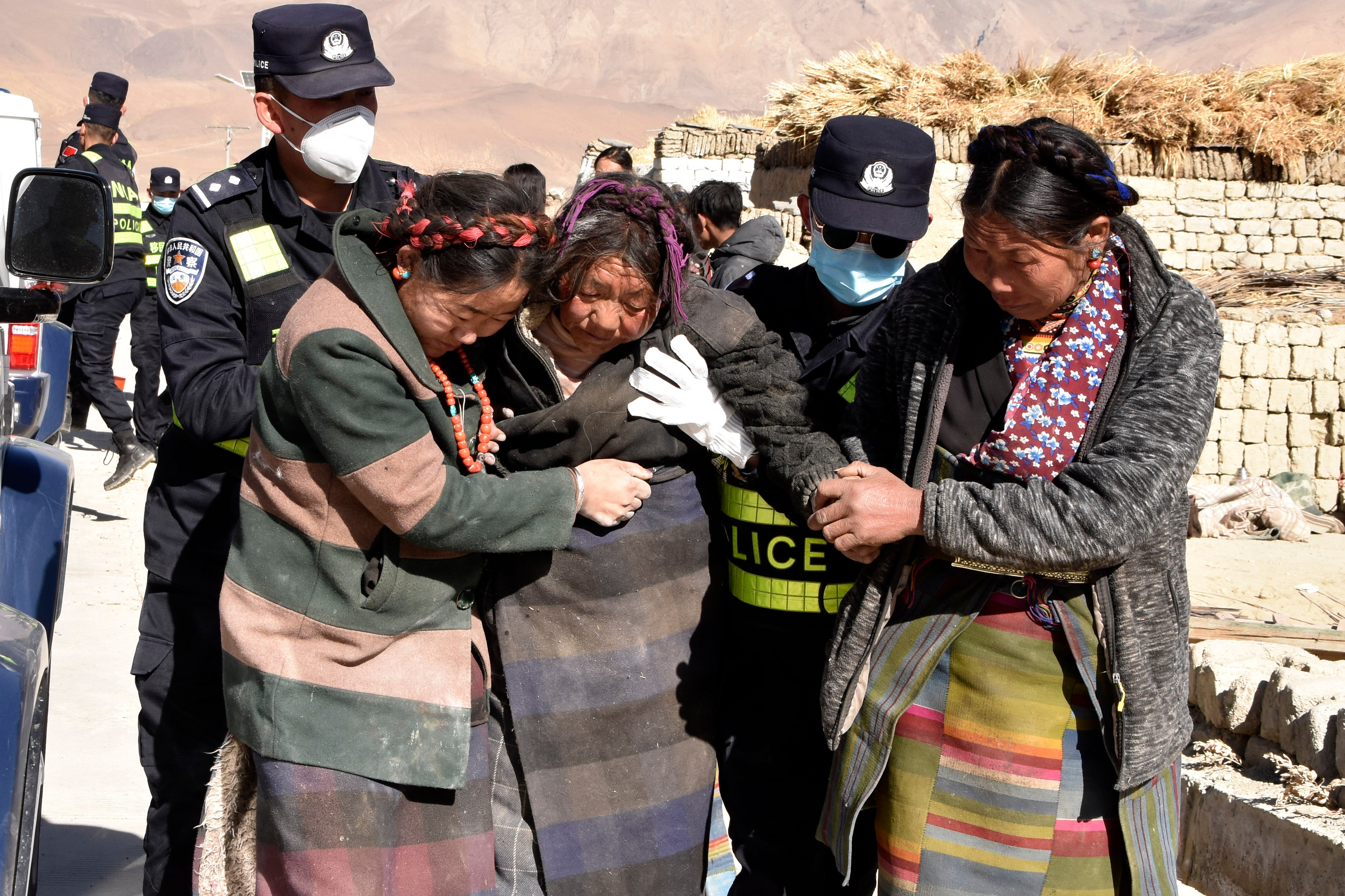 <p>Rescue workers assist the injured at Zhacun village in Tibet, China</p>