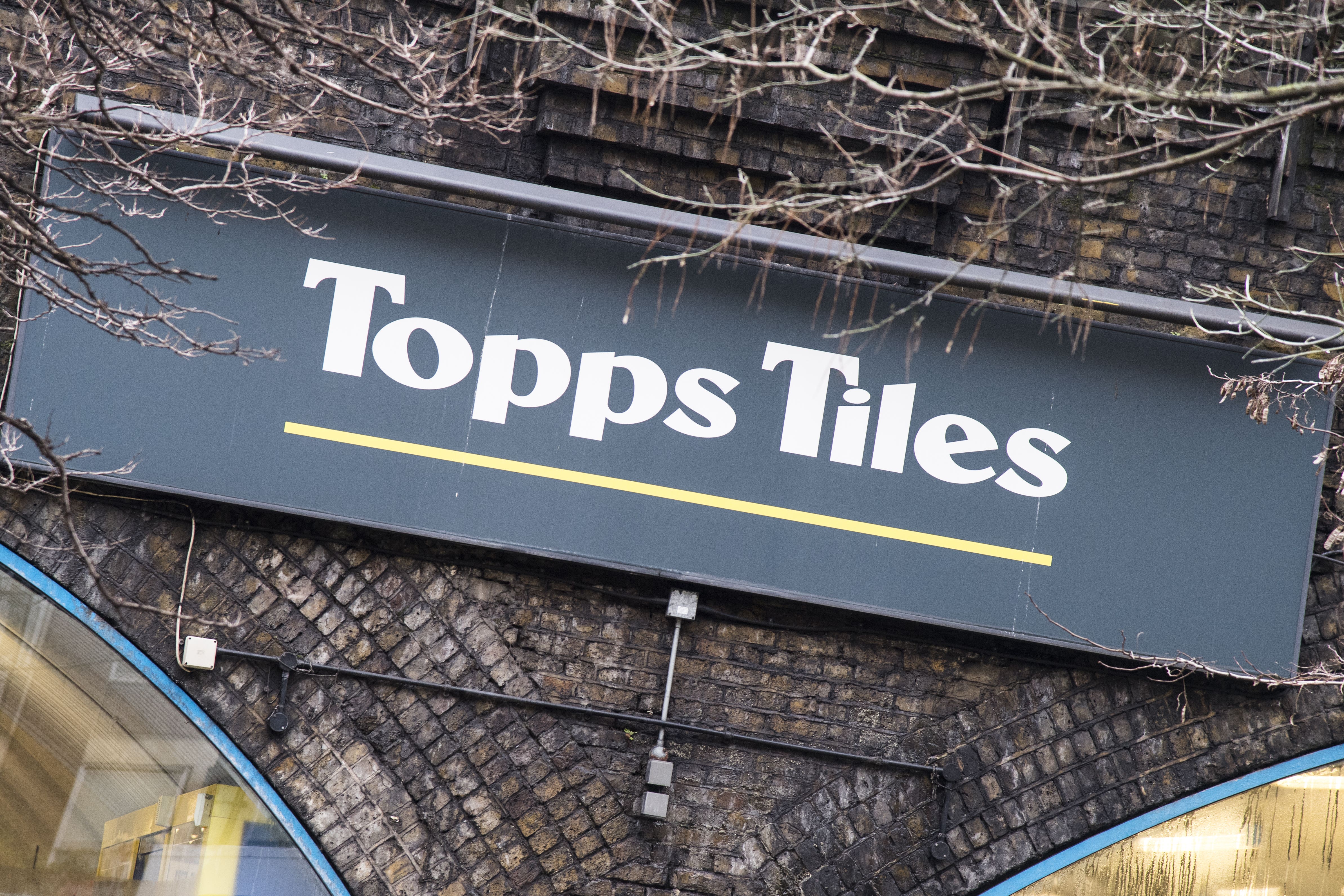 The boss of Topps Tiles has said he is retiring after 18 years at the retailer, as the company said it has returned to sales growth (Ian West/PA)