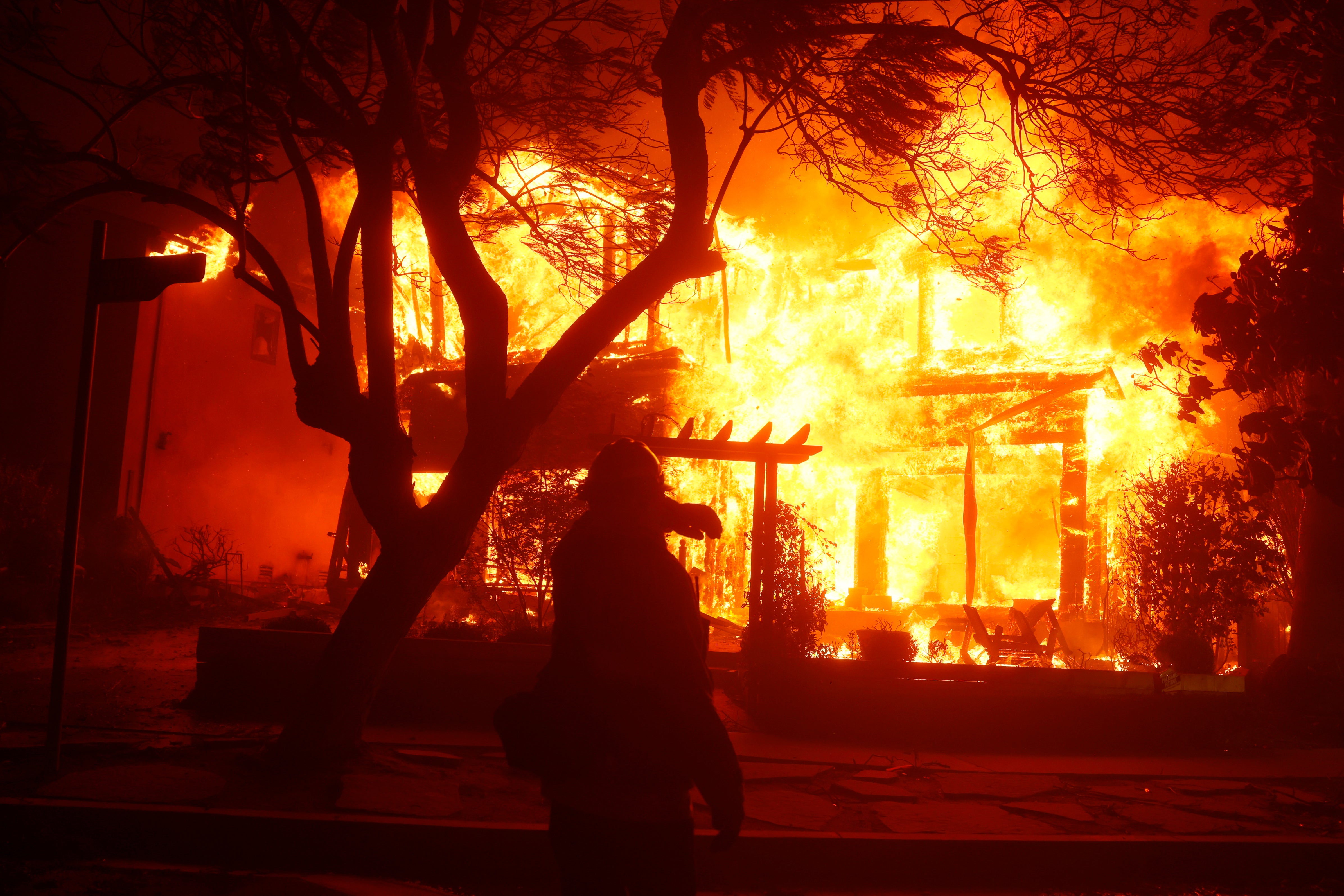 Apocalyptic pictures from the wildfire engulfing a home in the Pacific Palisades