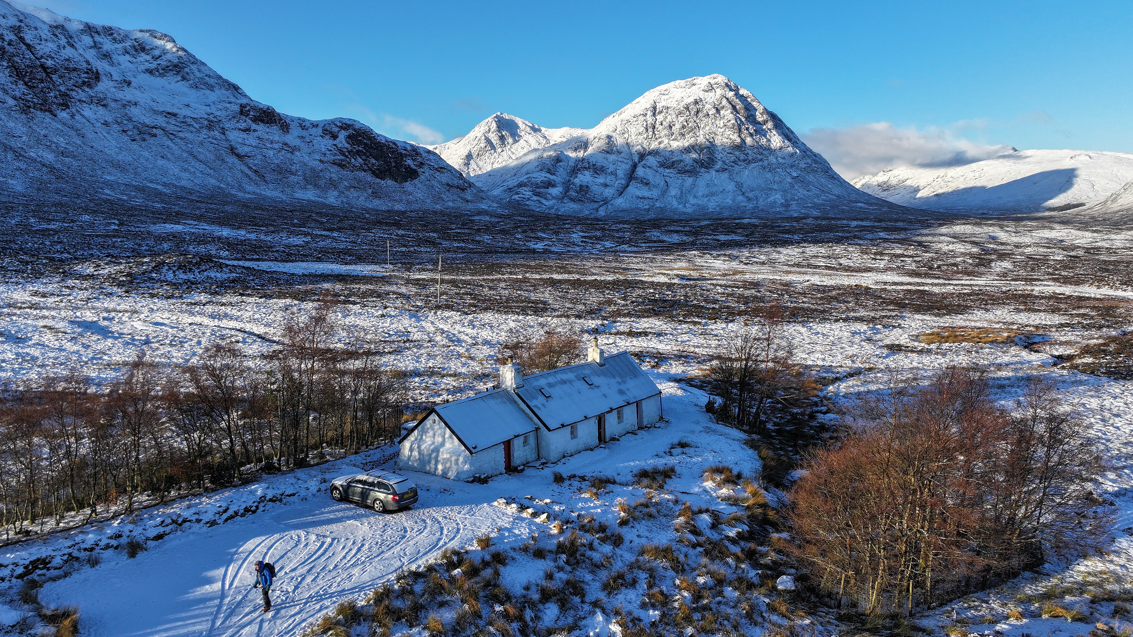 A climber is seen at Black Rock Cottage in front of Buachaille Etive Mor, Glencoe