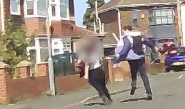 <p>The moment Ellis Dismore attacked the girl in the street (Cleveland Police/PA)</p>