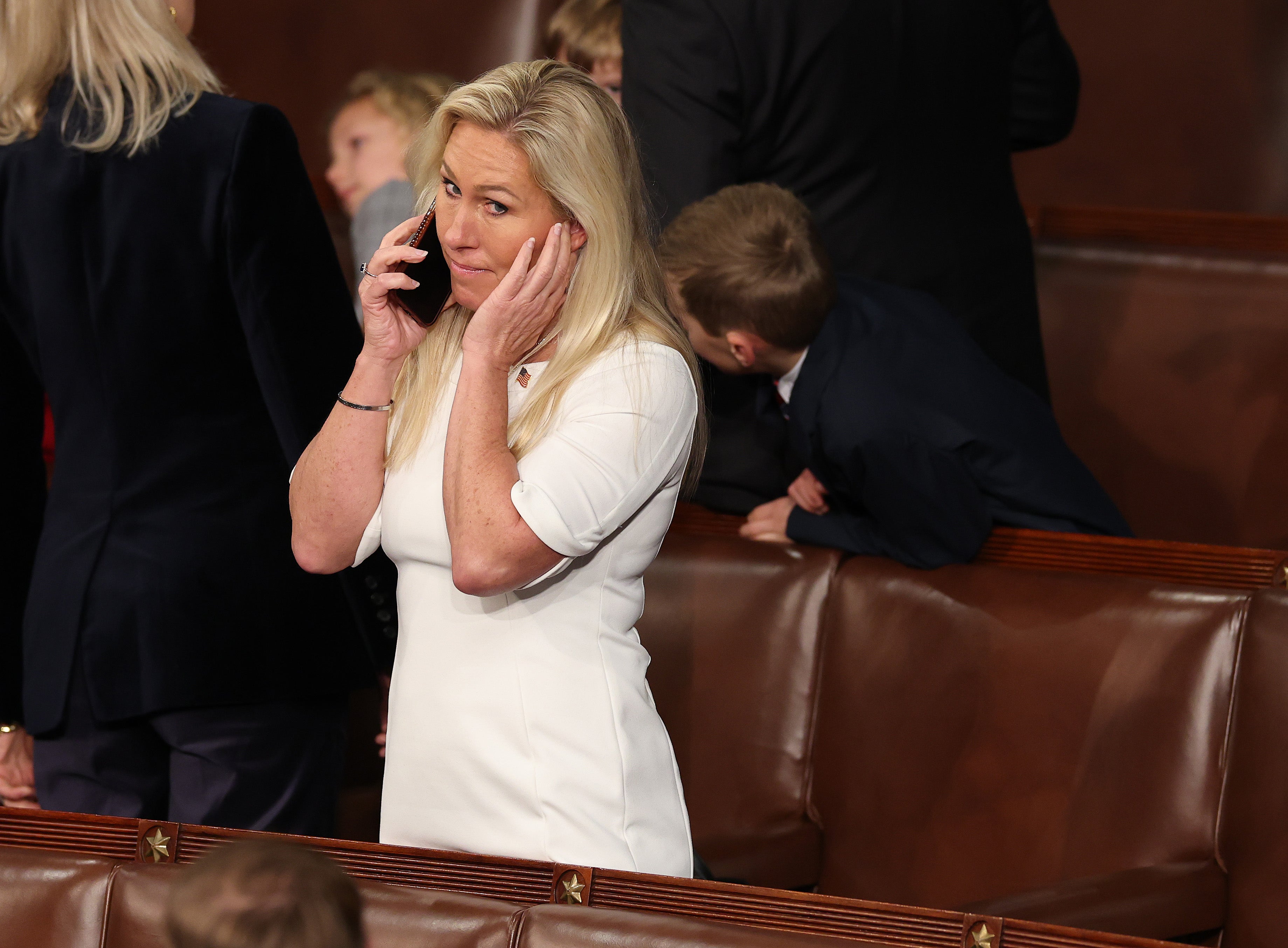 Marjorie Taylor Greene talks on the phone as the House votes for a Speaker of the House on January 3, 2025, in Washington, D.C. She has directed her staff to draft legislation renaming the Gulf of Mexico to the Gulf of America