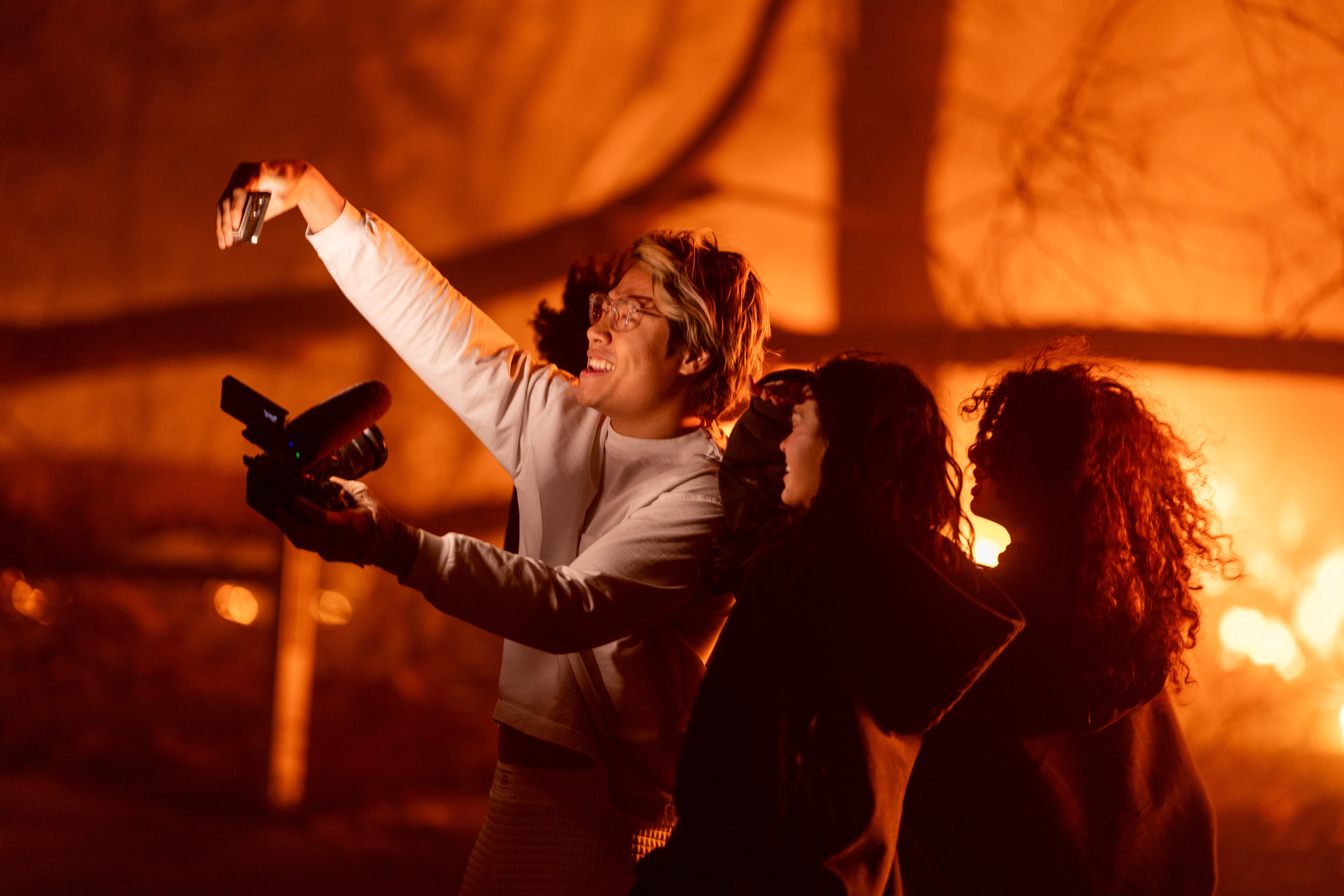 The group pose for a selfie in front of the raging wildfire in Pasadena