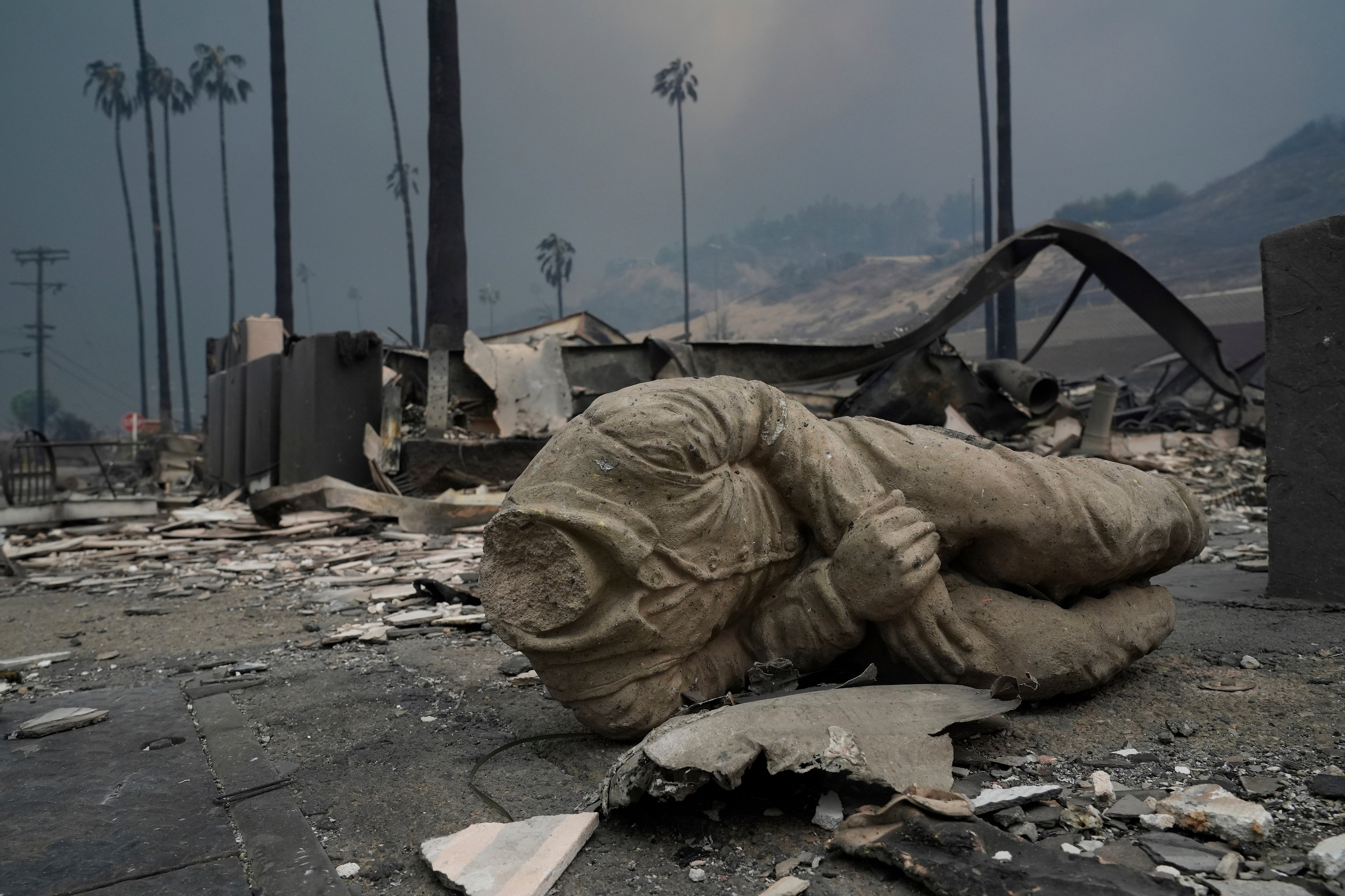 A statue and other structures are burned as the Palisades Fire continues to rage in Los Angeles, California, on Wednesday. Around a thousand structures have been burned, officials say