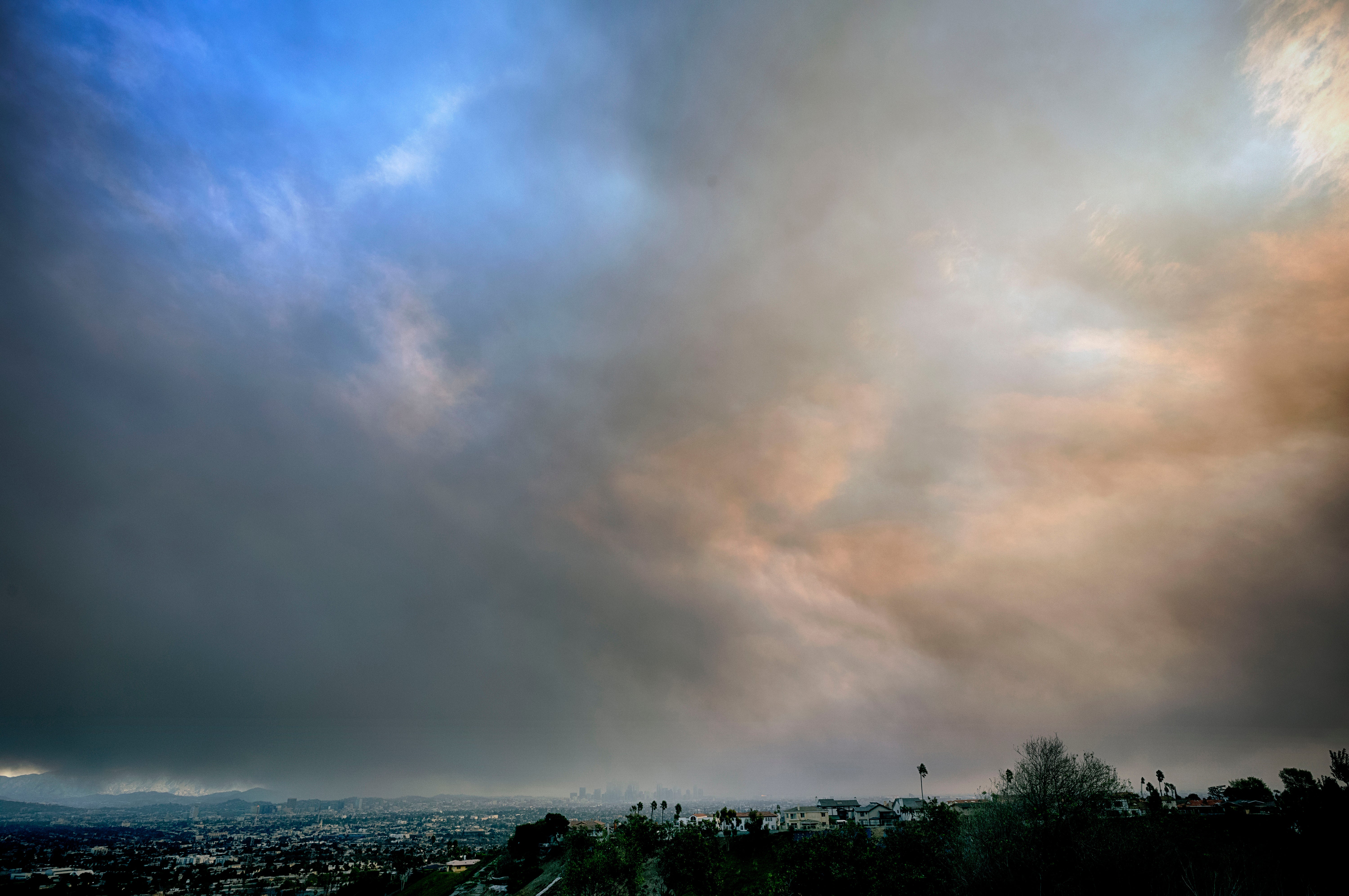 Thick heavy black smoke from wildfires moves over downtown Los Angeles, California, on Wednesday.