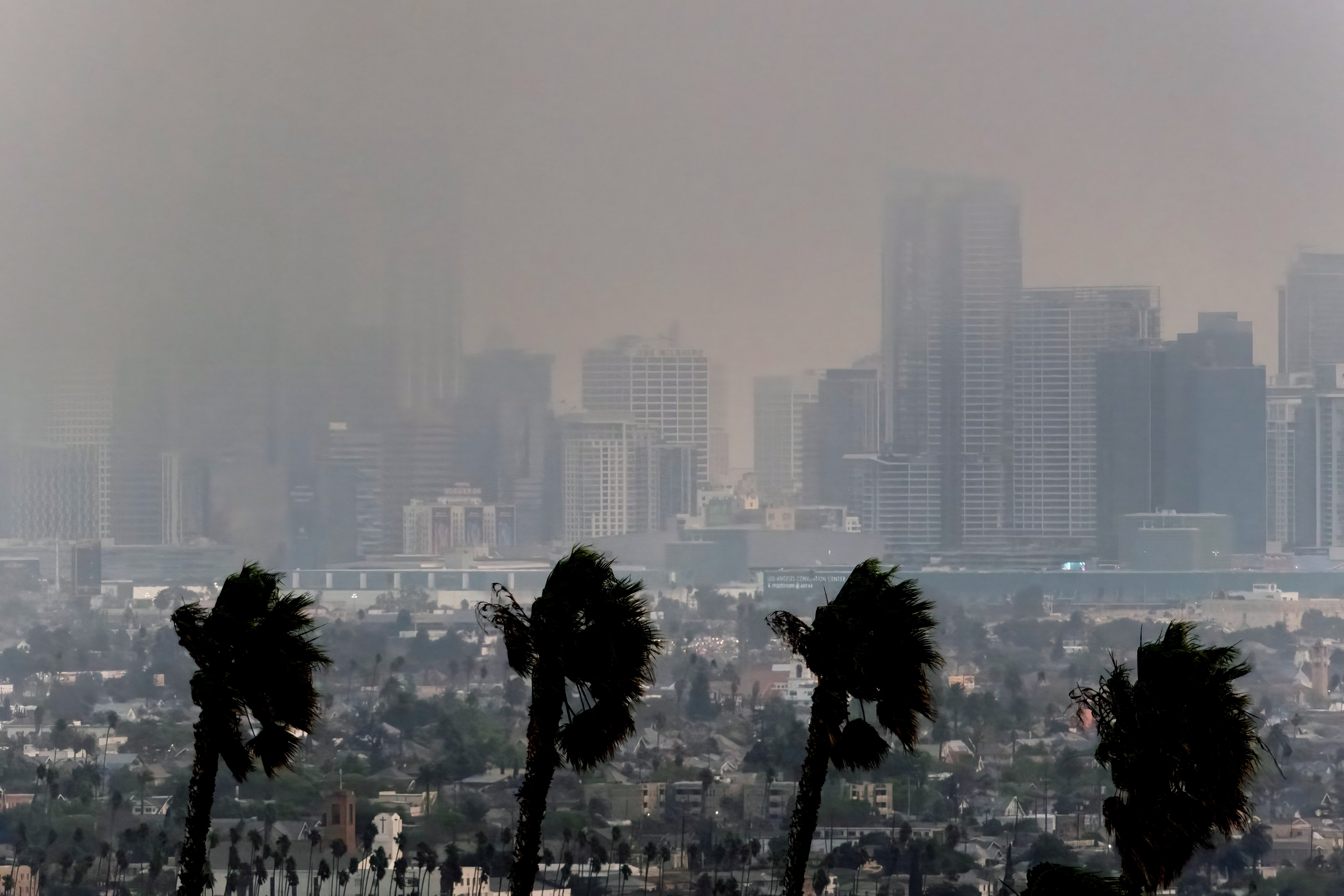 High winds blow as thick smoke from wildfires shrouds downtown Los Angeles on Wednesday in Southern California. The city’s air quality was slowly deteriorating there