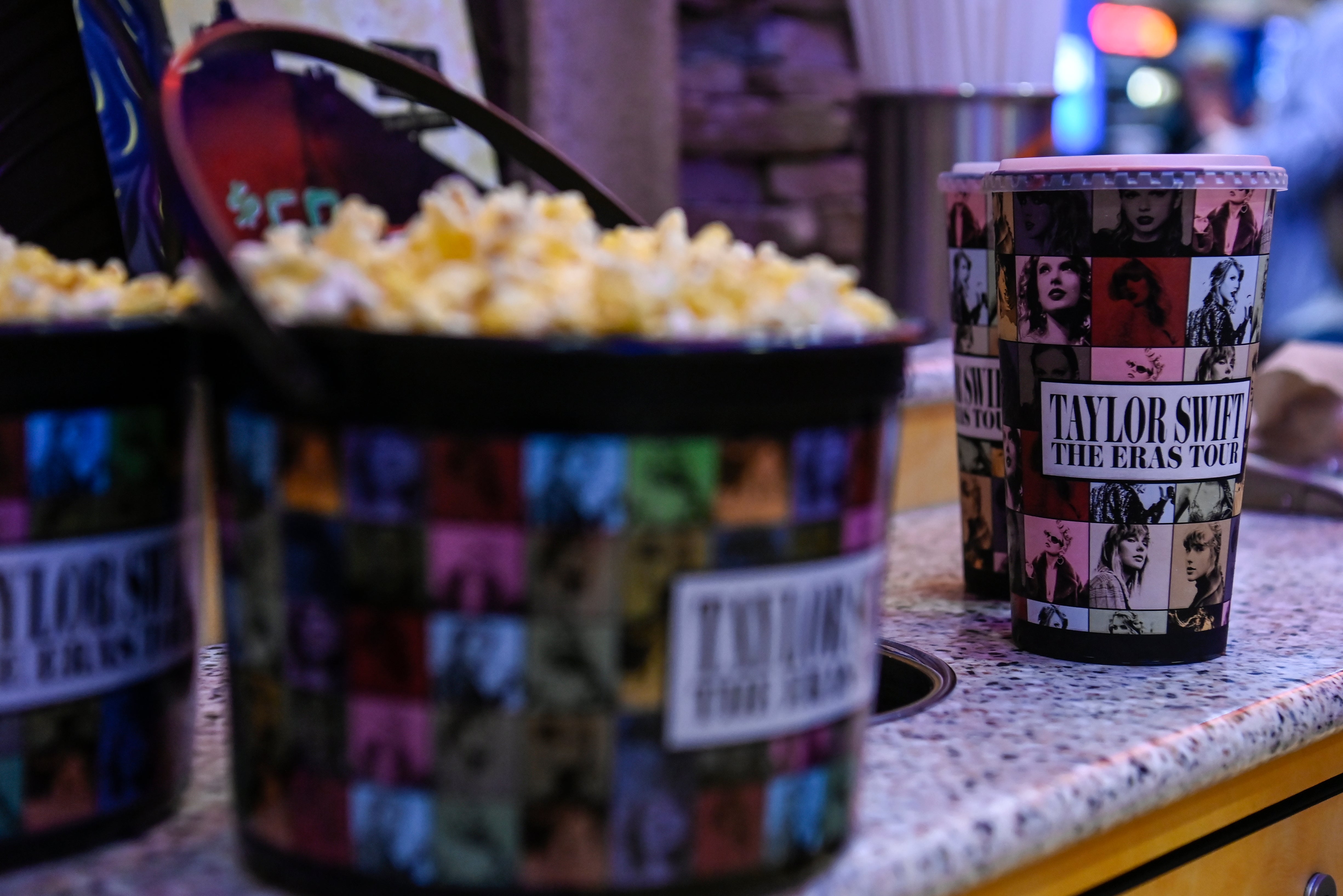 A collection bucket and cup for ‘Taylor Swift: The Eras Tour’ film is sold at Regal Cinemas