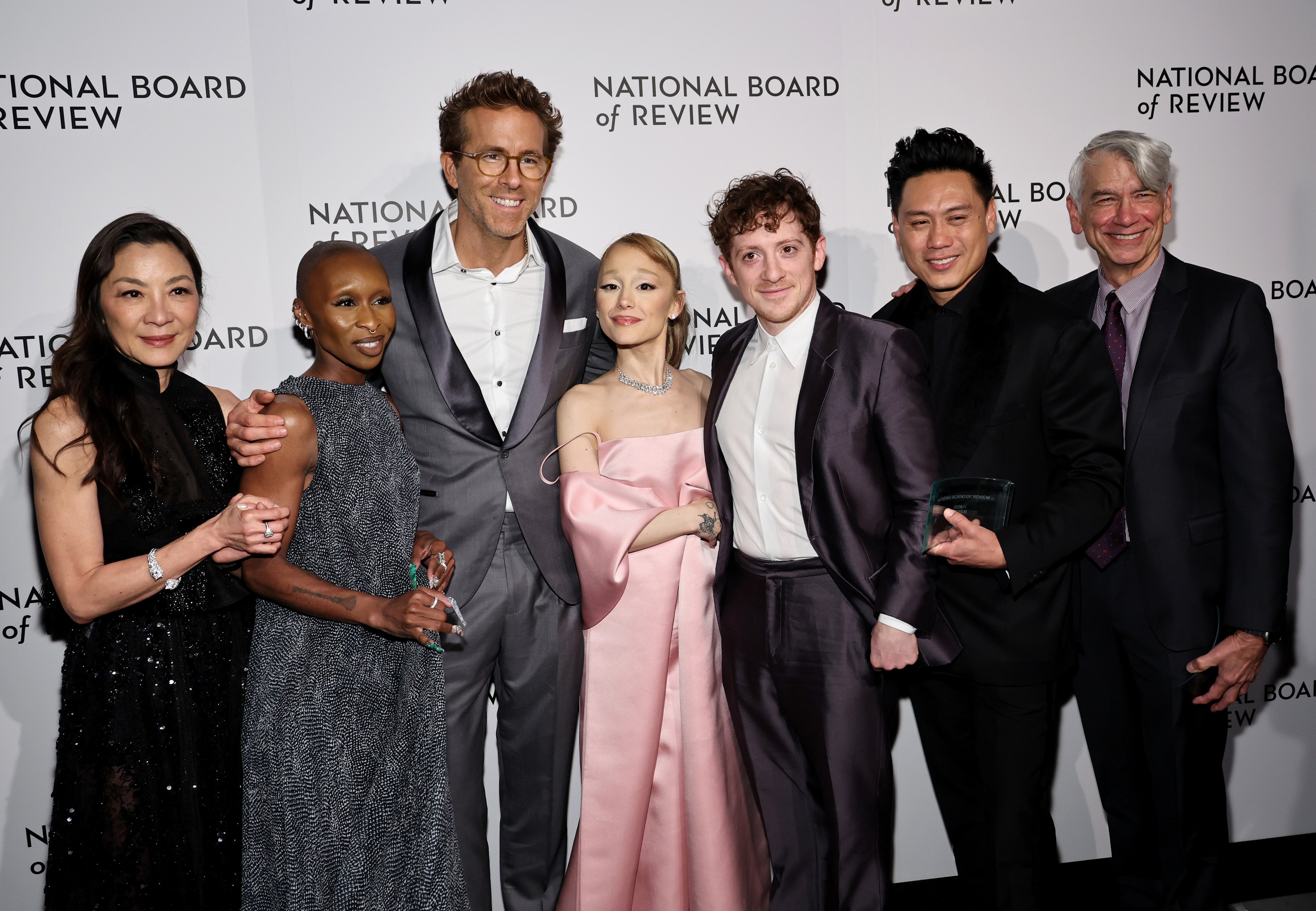 Michelle Yeoh, Cynthia Erivo, Ariana Grande, Ethan Slater, Jon M Chu and David Nicksay, winners of the Best Film Award for ‘Wicked,’ and Ryan Reynolds pose at The National Board of Review Annual Awards Gala