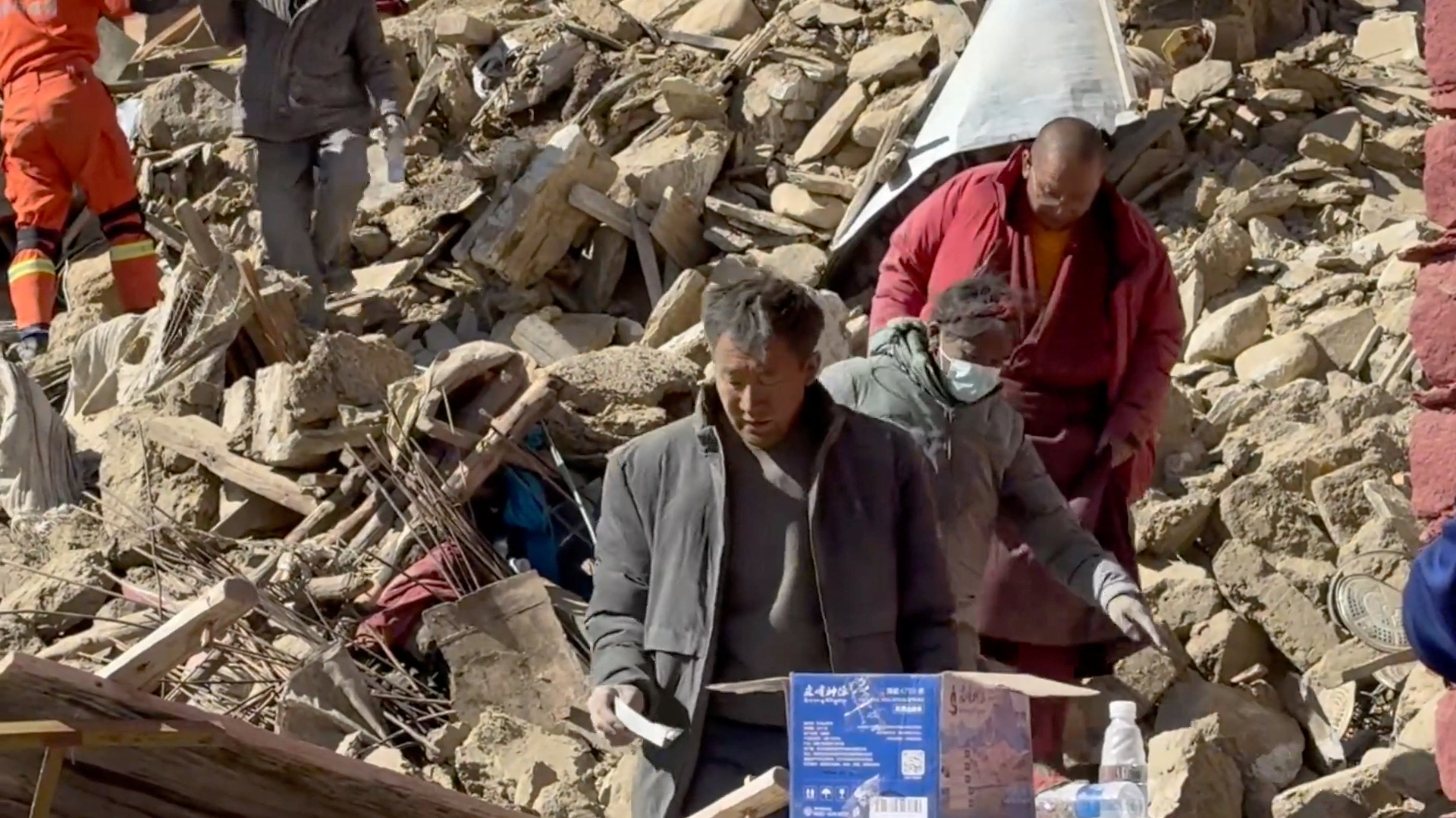 Rescue teams work amidst rubble in the aftermath of an earthquake in a location given as Shigatse City, Tibet Autonomous Region