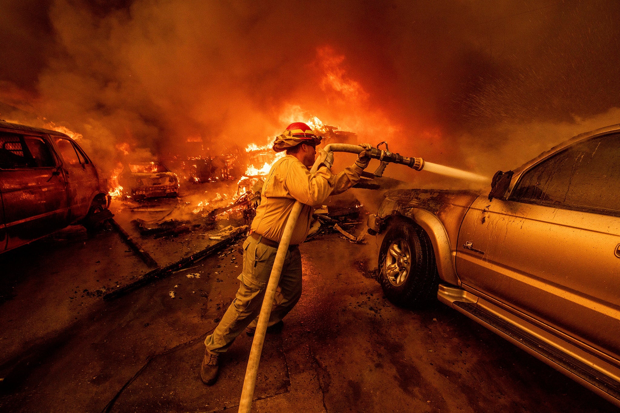 A firefighter battles the Eaton Fire Wednesday evening