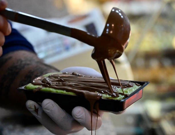 Shop owner Ali Fakhro prepares Dubai chocolate at his Abu Khaled Sweets oriental pastry shop in Berlin