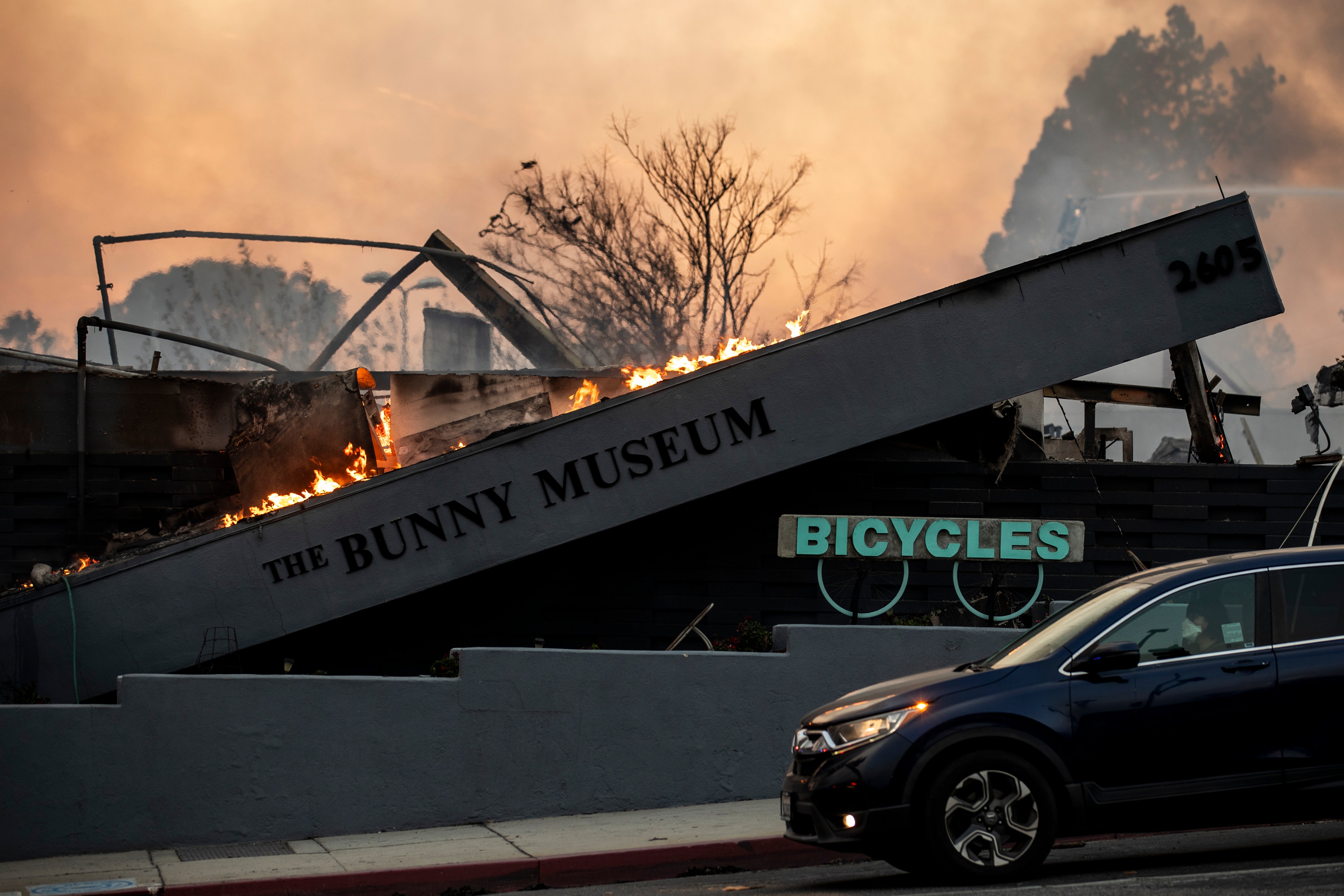 The same angle shows the museum collapsed and ablaze