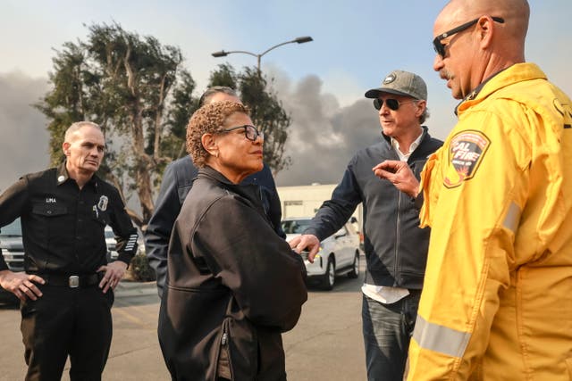 <p>Los Angeles Mayor Karen Bass, pictured with and California Governor Gavin Newsom on Wednesday, was absent when the first fires broke out across LA </p>