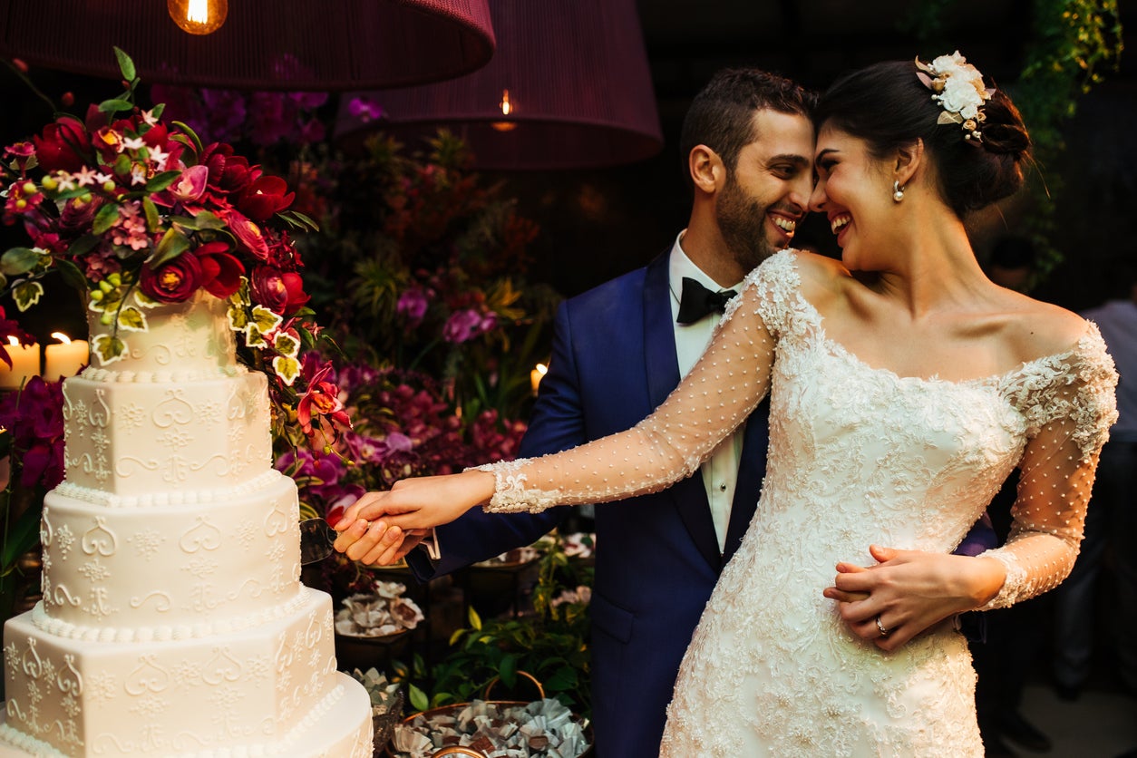 Bride and groom cutting their cake at reception