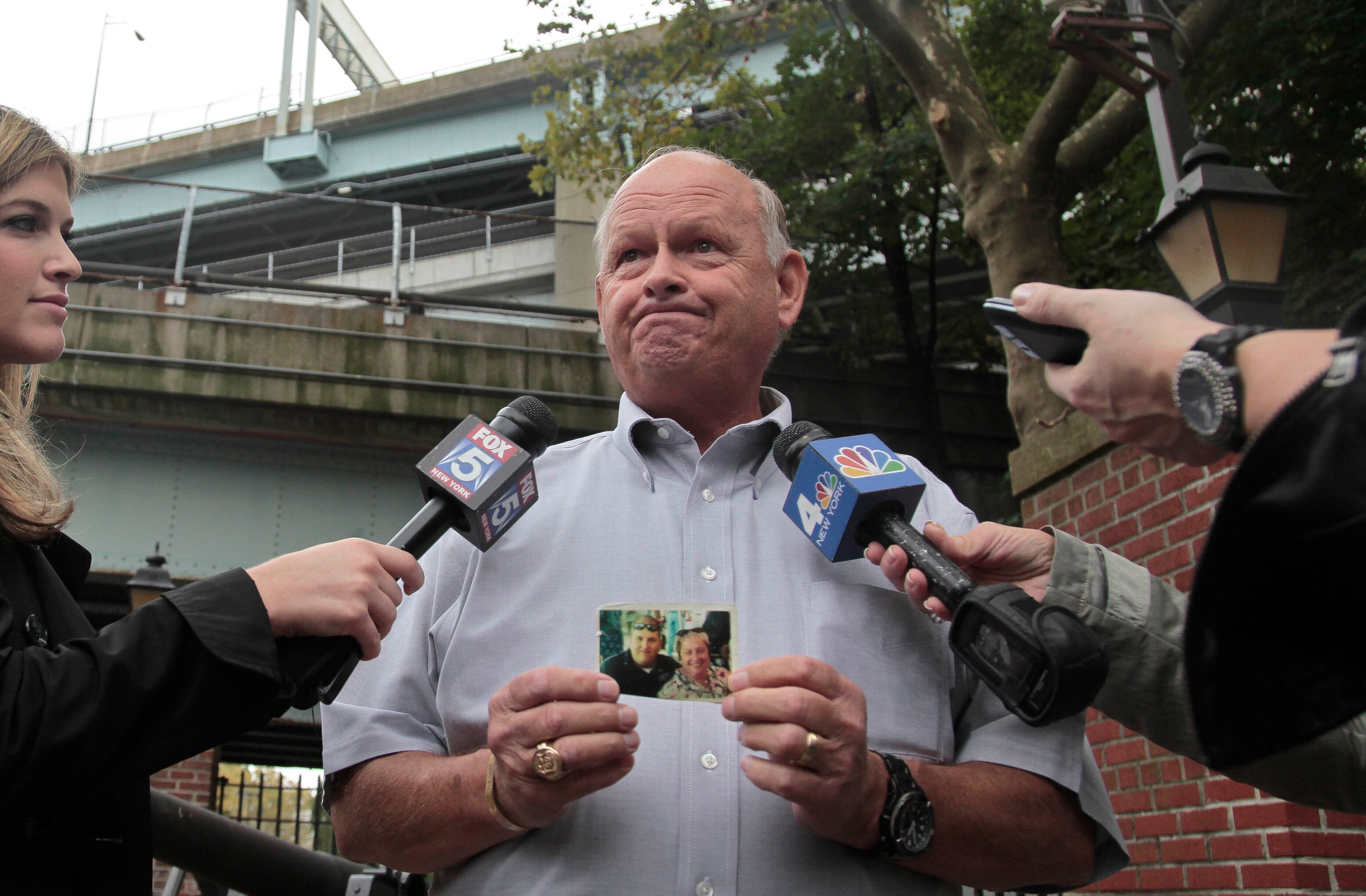 Ken Fairben, holding a photo showing his son Keith who died in the Sept. 11 attacks, said that there is some meaning in seeing a guilty plea.