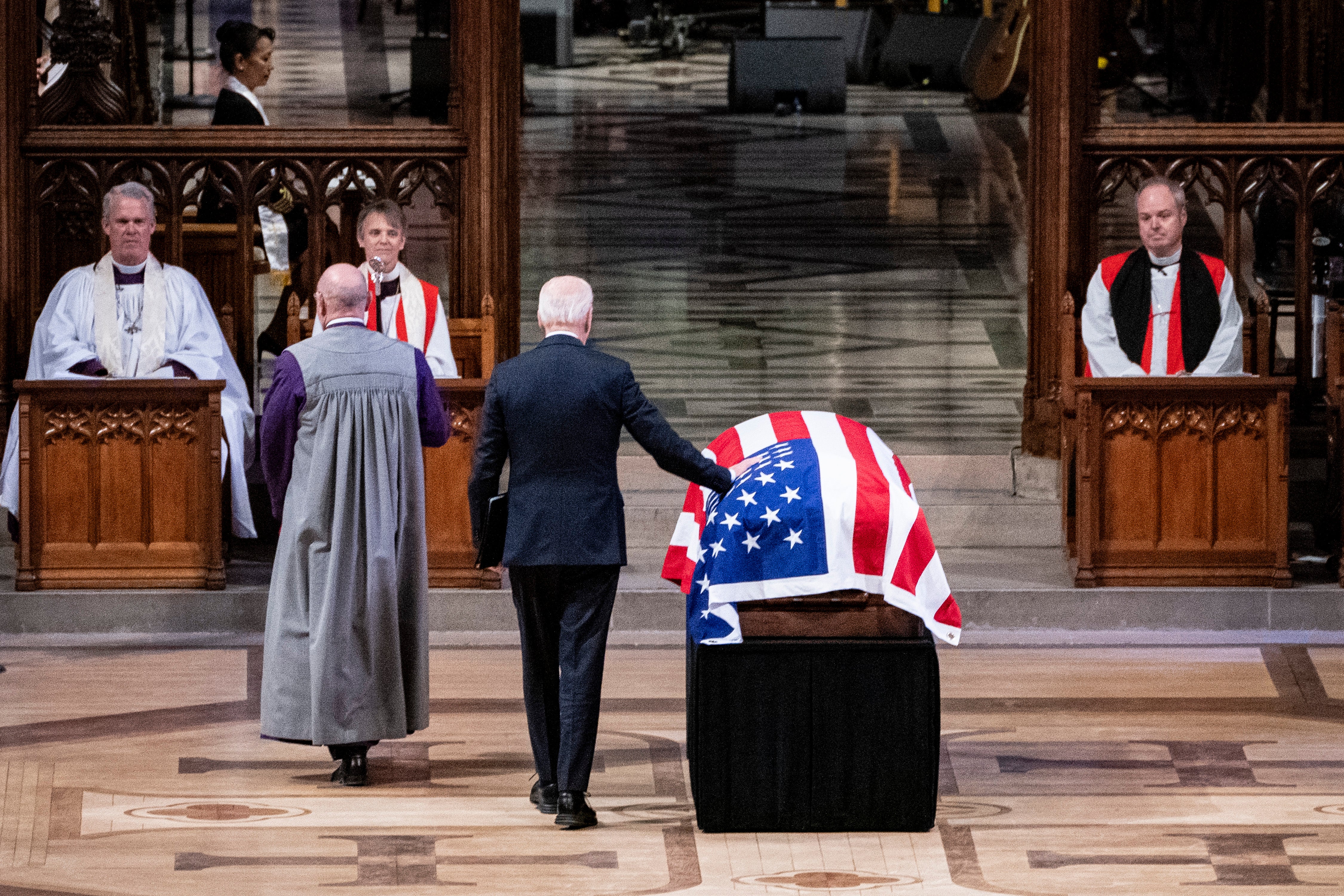 President Joe Biden touches the casket before delivering remarks at the state funeral of former U.S. President Jimmy Carter at Washington National Cathedral. Carter’s faith helped shape him as a politician and he’s remembered for his beliefs as much as his work in Washington