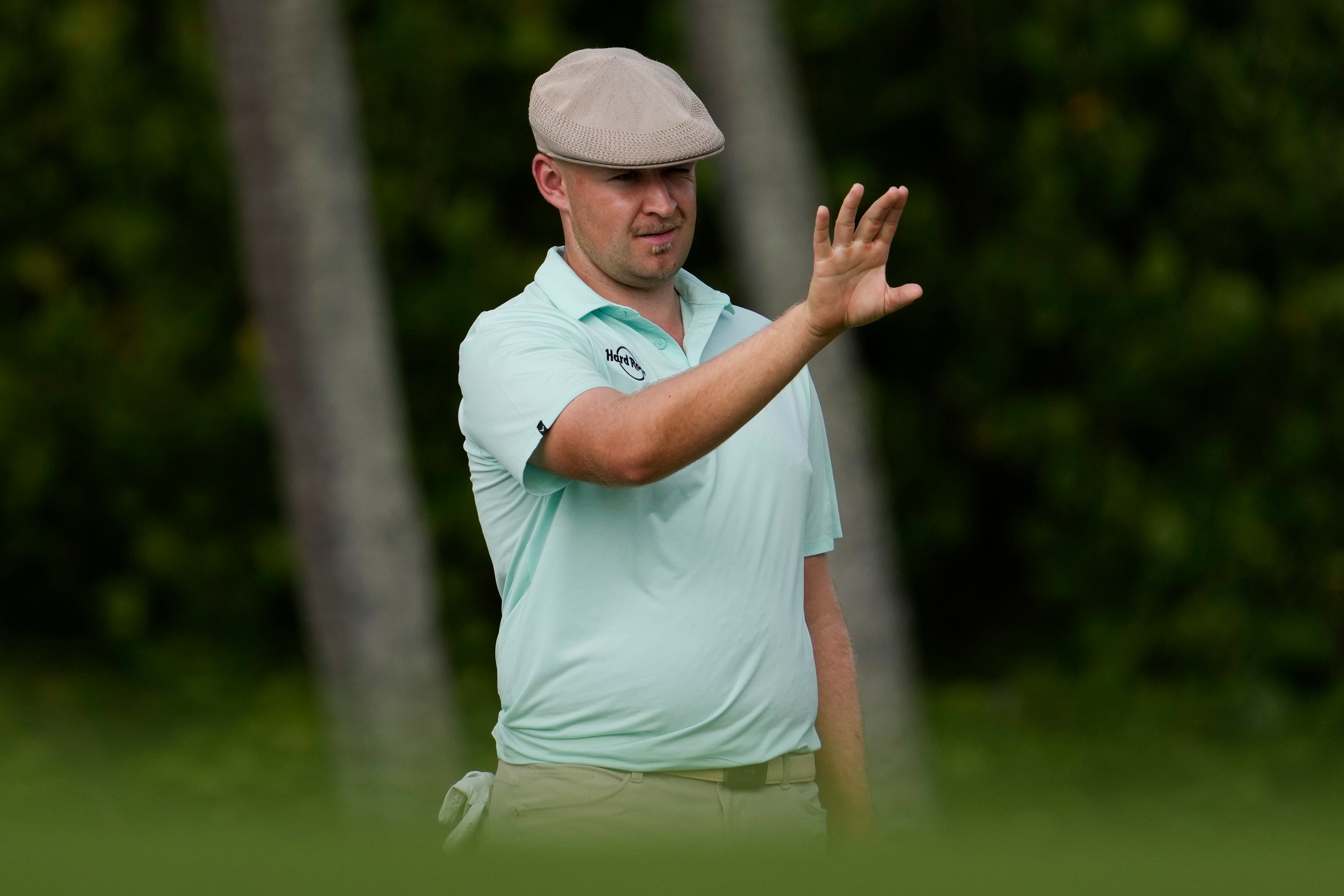 Harry Hall, of England, lines up his shot on the 13th hole during the first round of the Sony Open (Matt York/AP)