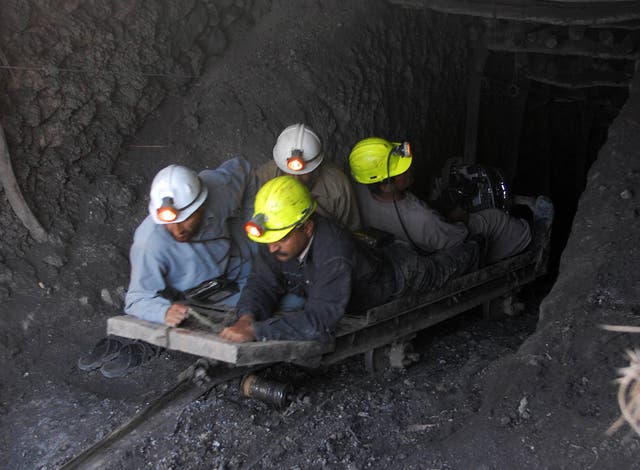 <p>File. Miners join a search for fellow workers at a coal mine following a gas explosion</p>