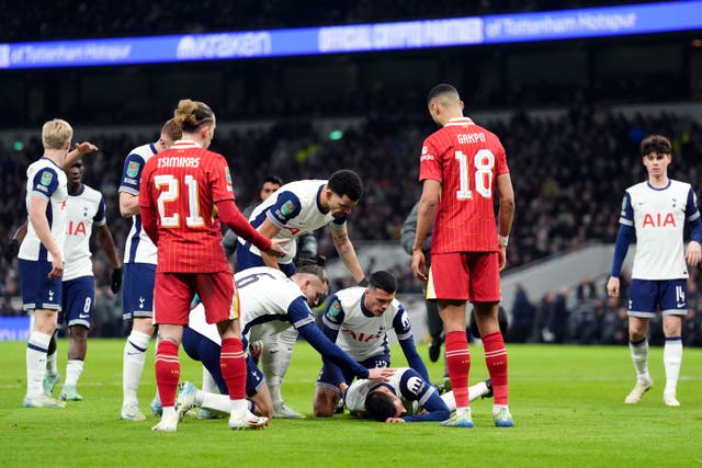 Rodrigo Bentancur is checked by team-mates after he suffered a suspected head injury during Tottenham’s 1-0 win over Liverpool (Adam Davy/PA)