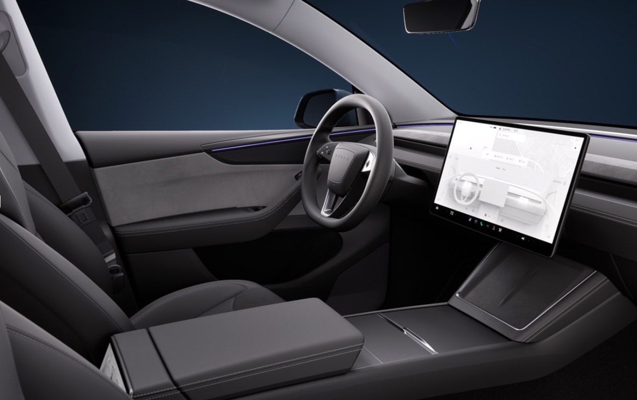 The interior of the 2025 Tesla Model Y features upgraded materials, but the indicator and gear selector stalks have disappeared.