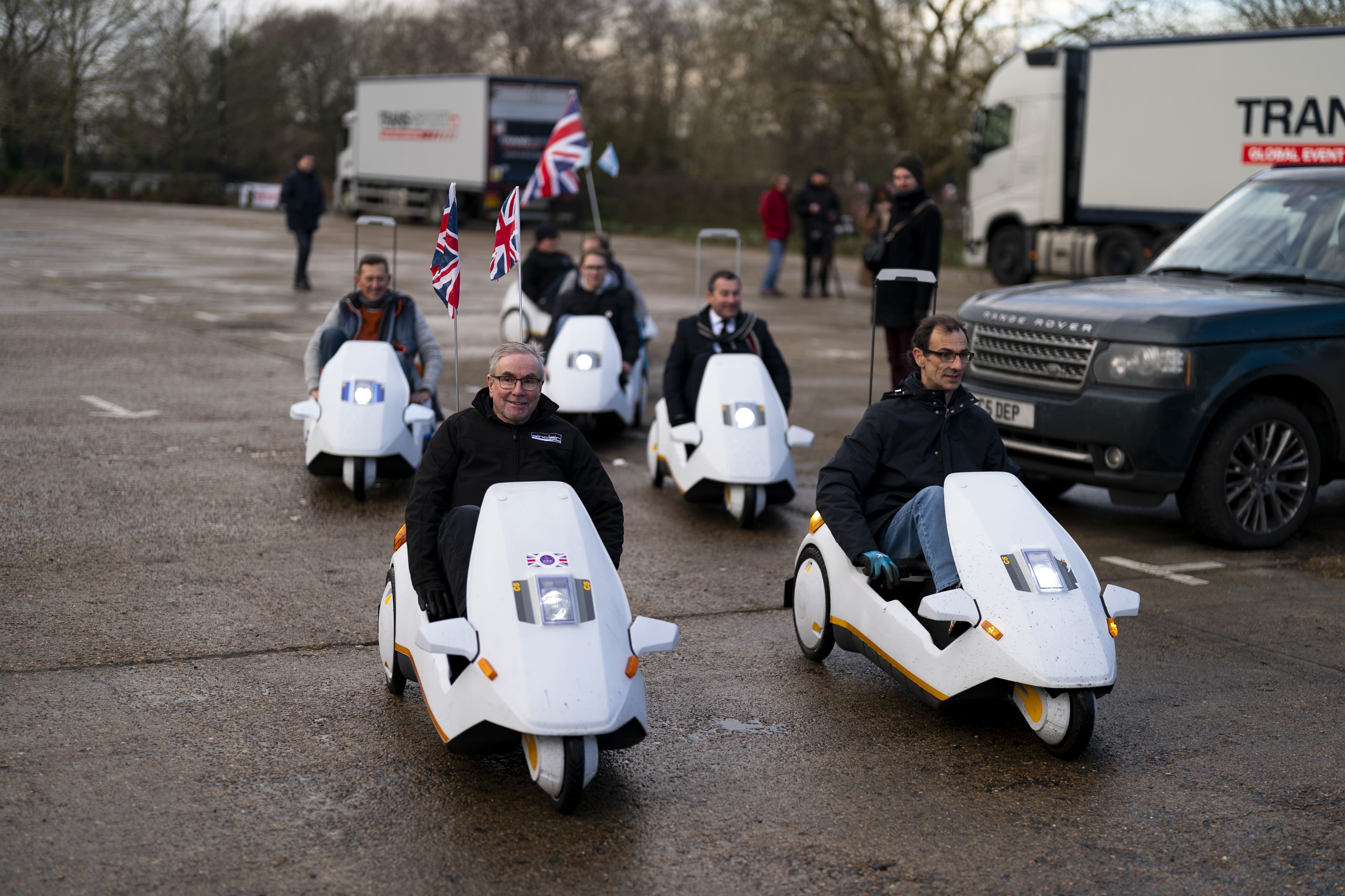 Sinclair C5 enthusiasts enjoy the gathering at Alexandra Palace in London (Jordan Pettitt/PA)