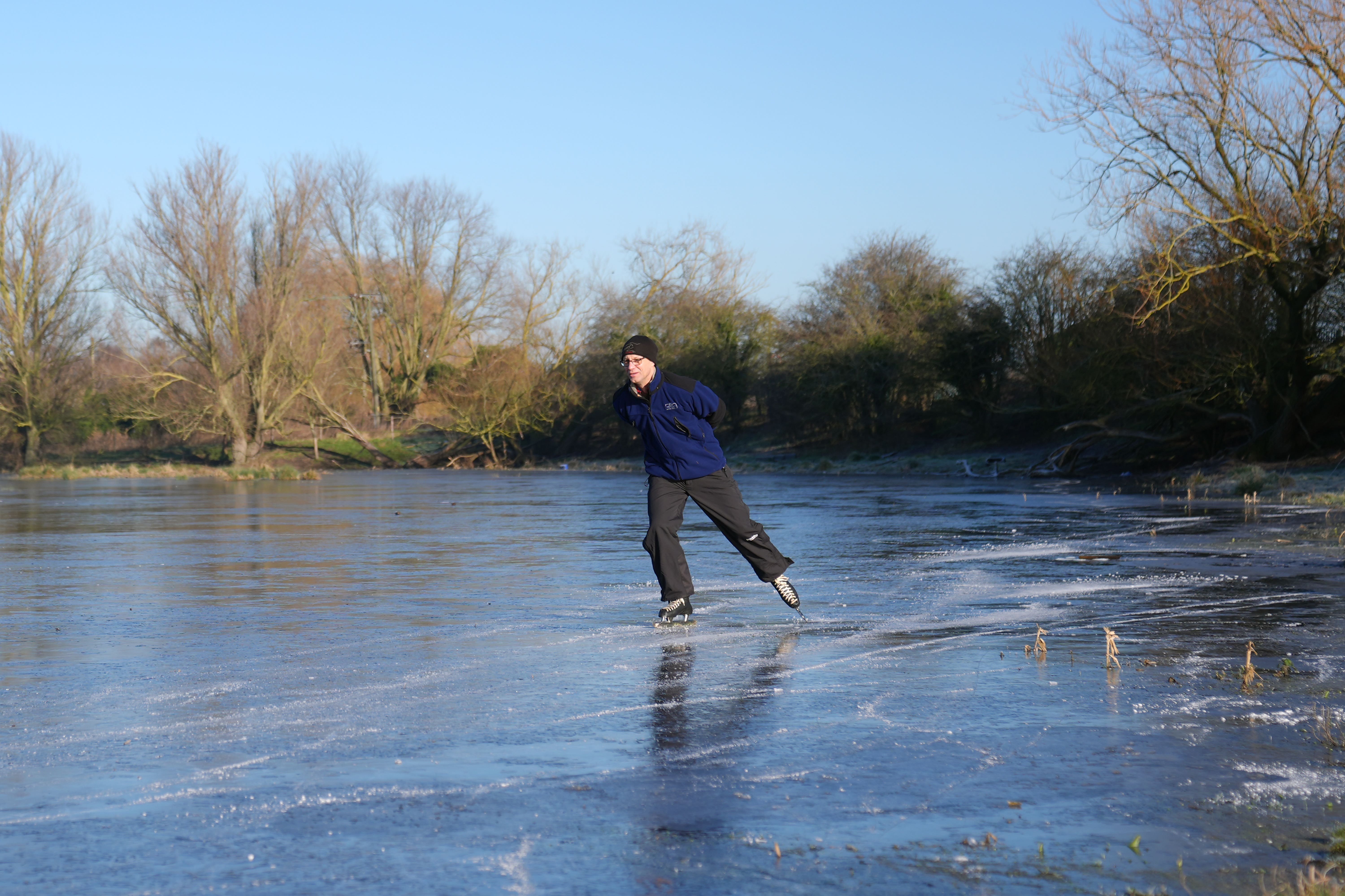 Paul Jansen skates on a frozen flooded field in Upware, Cambridgeshire (Joe Giddens/ PA)