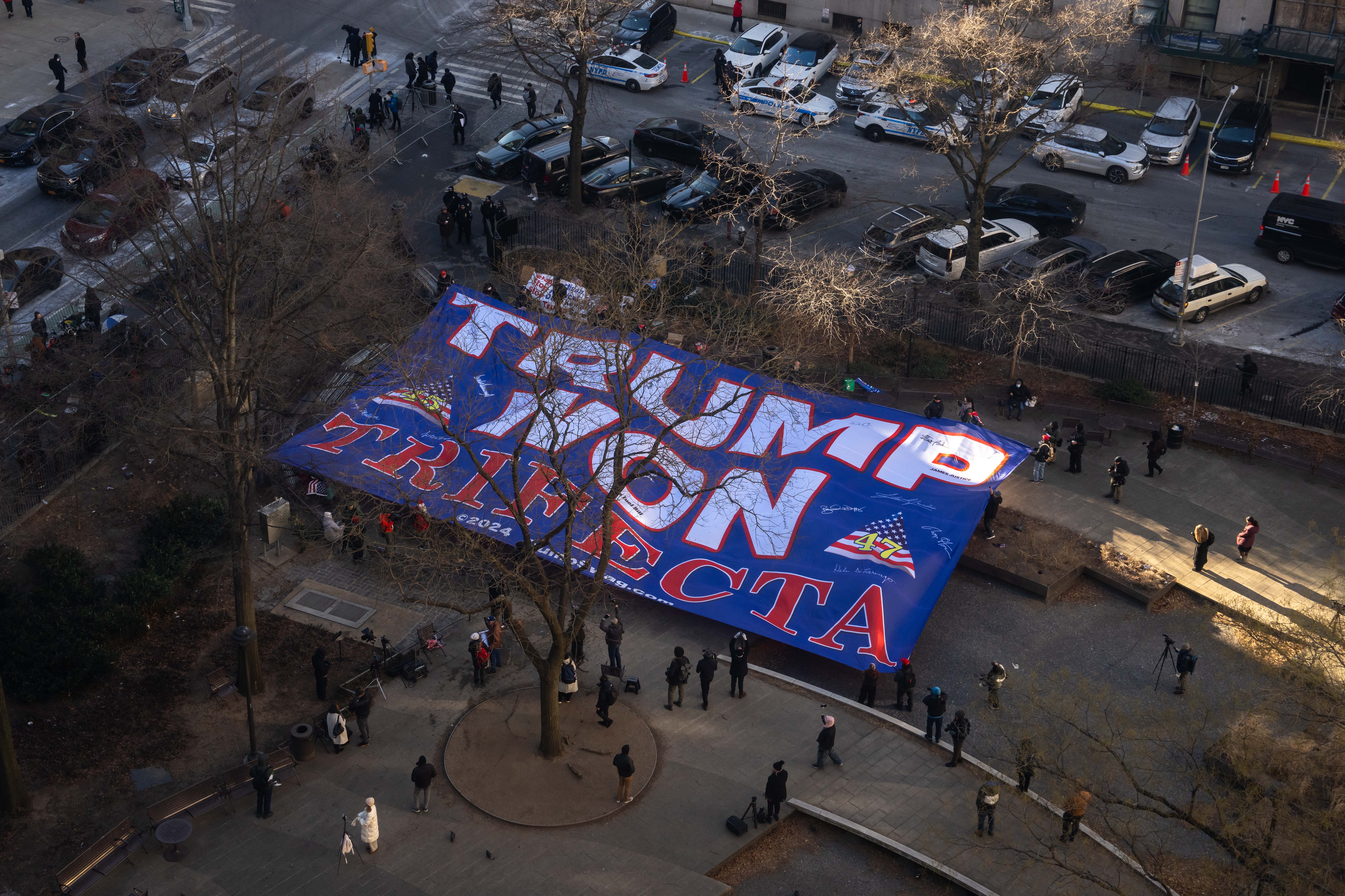 A Trump flag sits outside Manhattan Criminal Court, where the president-elect was sentenced on Friday in his business records case. Trump will face no jail time or fines related to his felony convictions