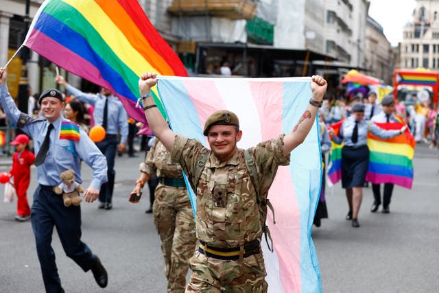 <p>A member of the British Army carries a transgender flag during the Gay Pride Parade more than 20 years after the ban on gay and lesbian personnel was repealed </p>