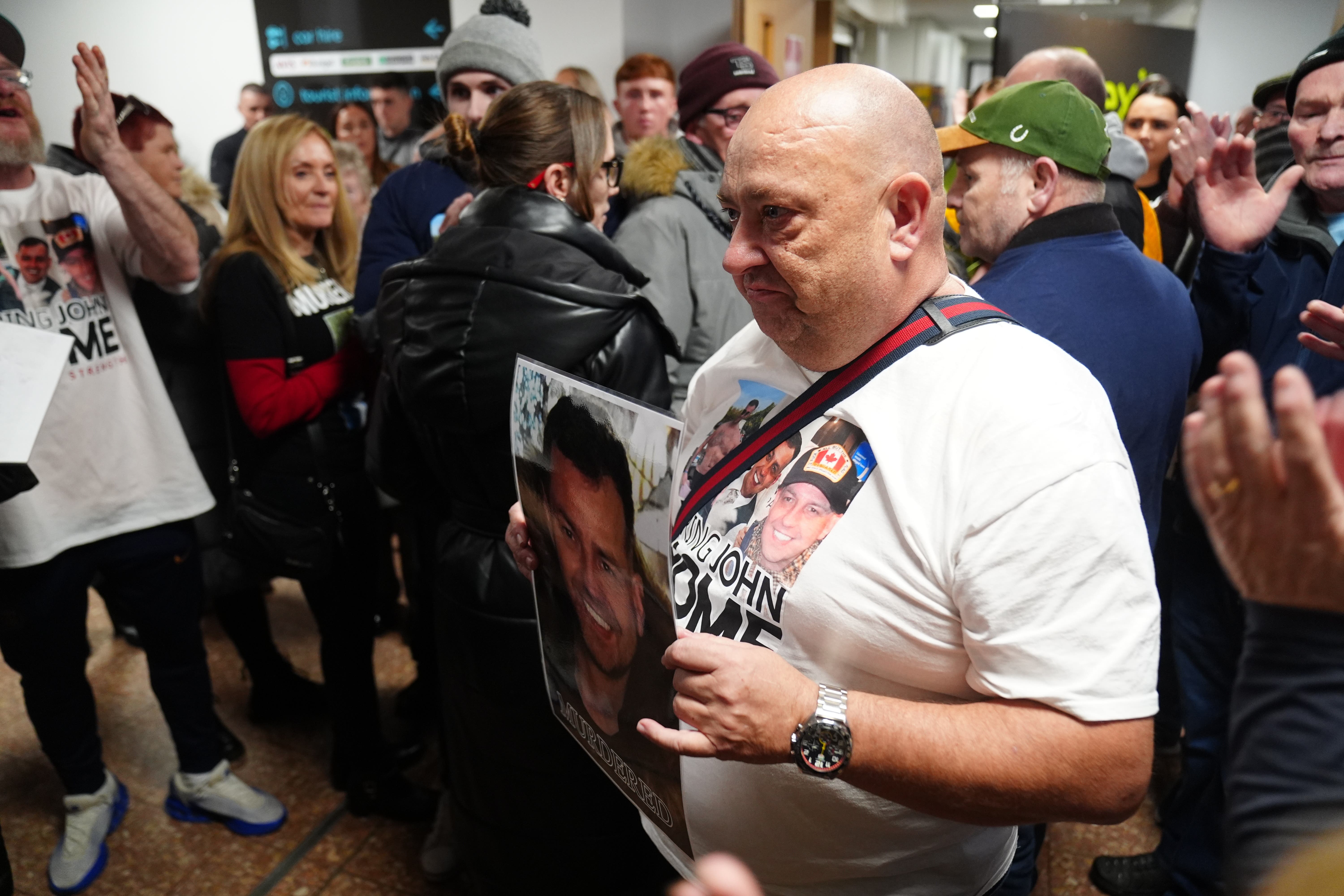 John George’s father Billy (centre right) and other family members return to Belfast Airport (Brian Lawless/PA)