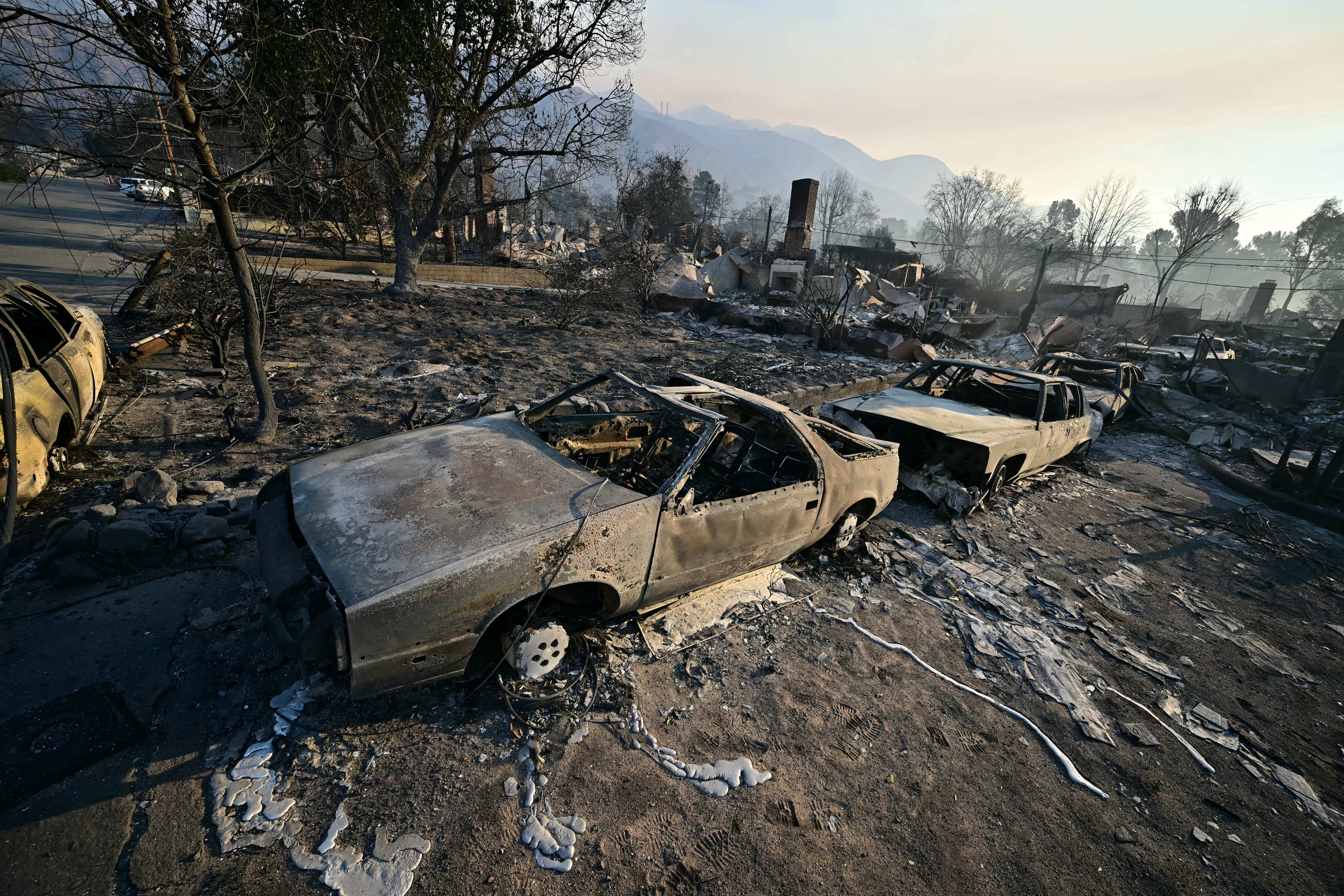 Burned-out cars and homes reduced to rubble by the Eaton Fire are seen in Altadena, California, on Friday. The fire was 3 percent contained