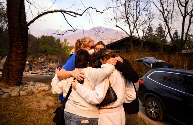 <p>A family cries as they discover their Altadena home was scorched by the Eaton Fire on Thursday. Several residents like them are now returning to find their homes were destroyed by the flames </p>